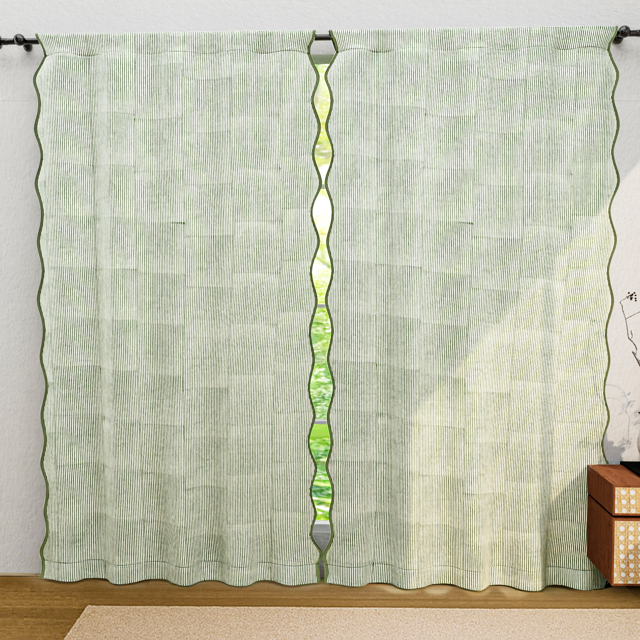 Green curtain with a decorative panel on a white wall