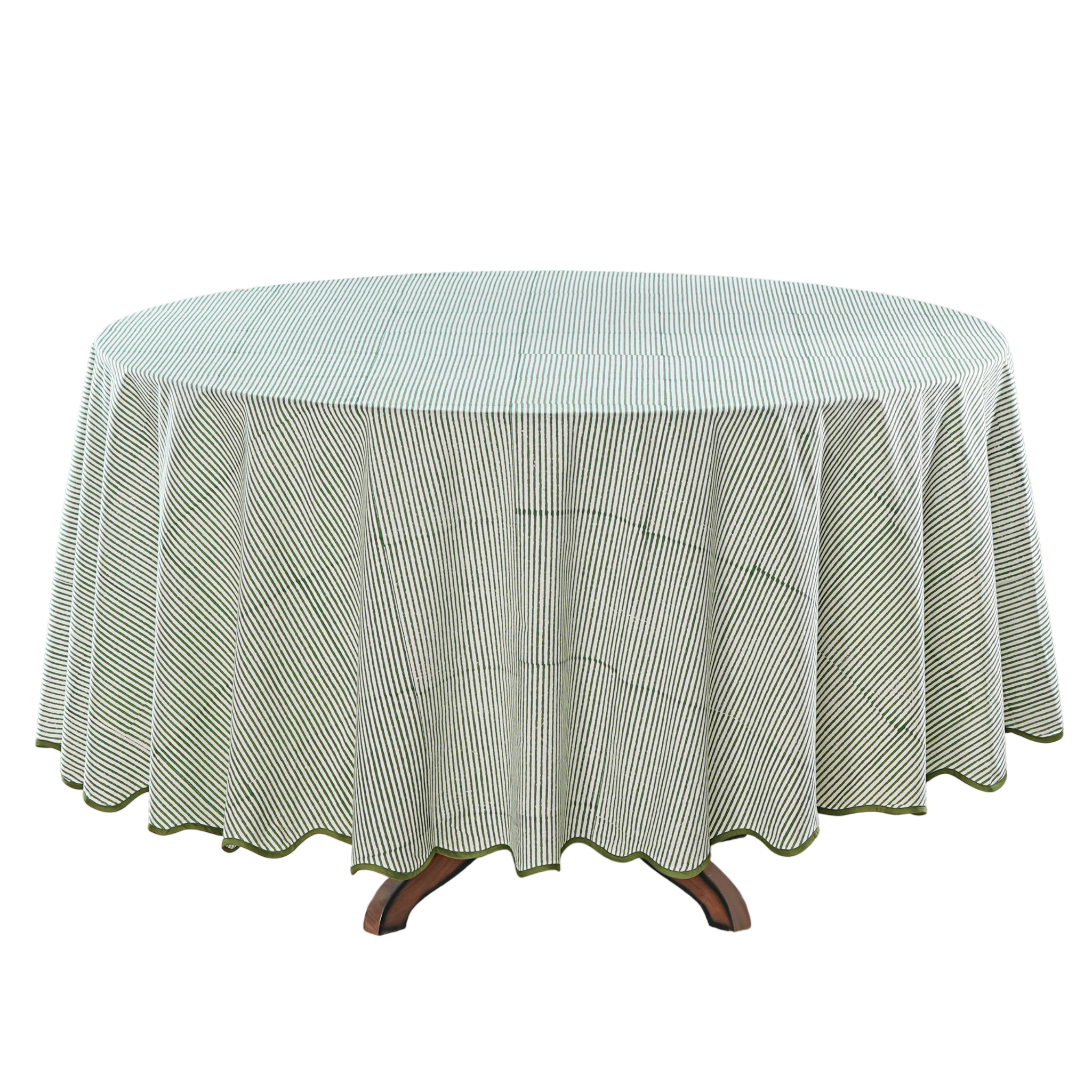 Round table covered with a green and white checkered tablecloth on a white background