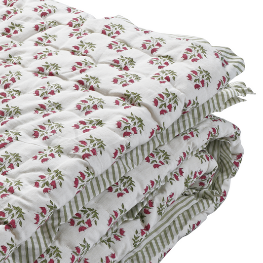 Floral and striped quilt on a white background