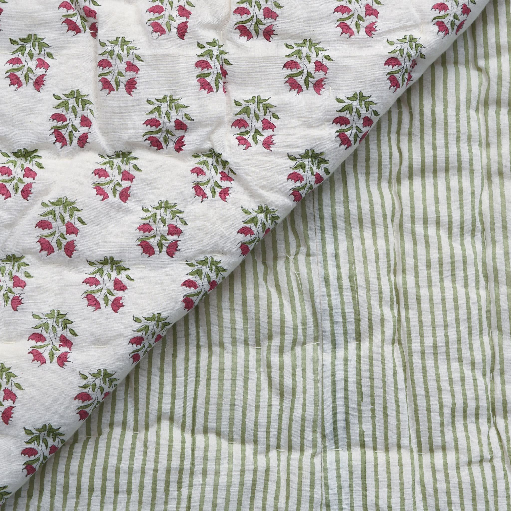 Floral and striped fabric patterns on a quilted surface