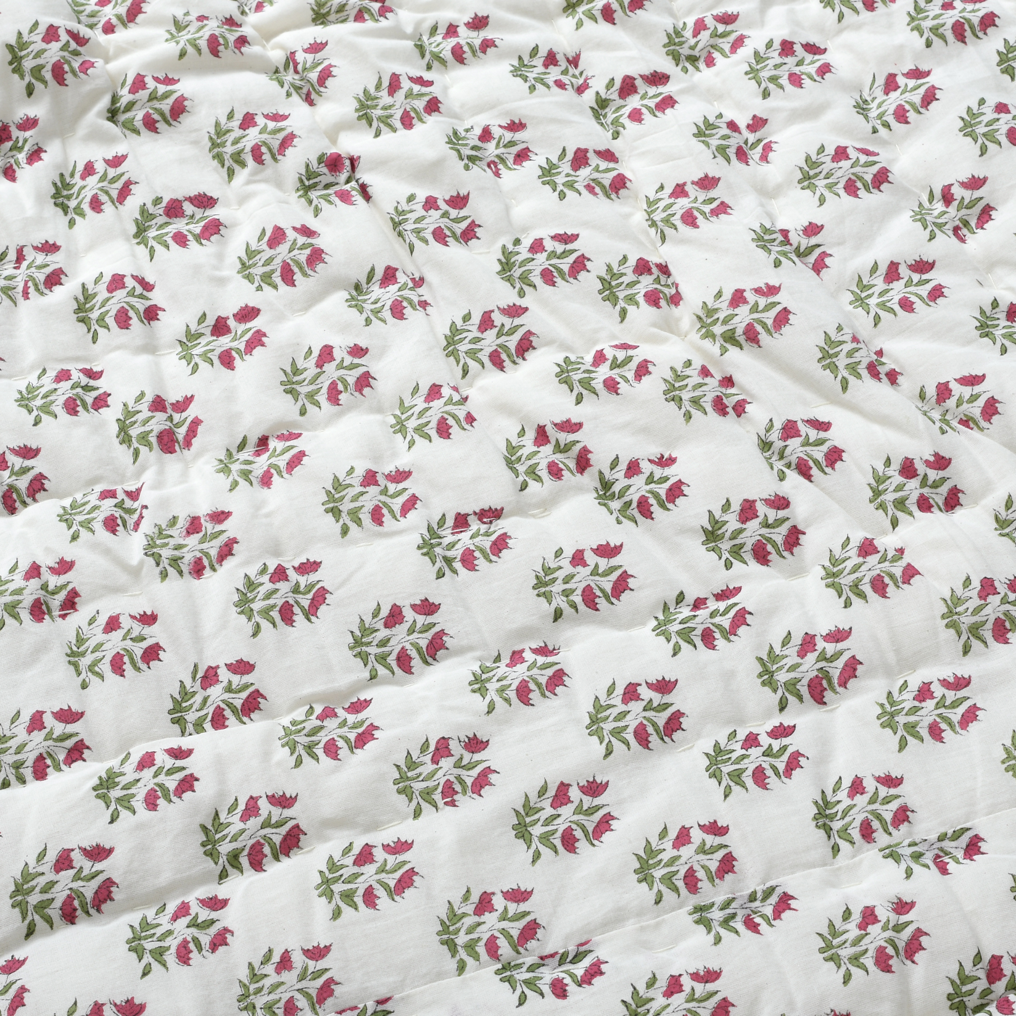 Floral patterned fabric with pink and green flowers on a white background