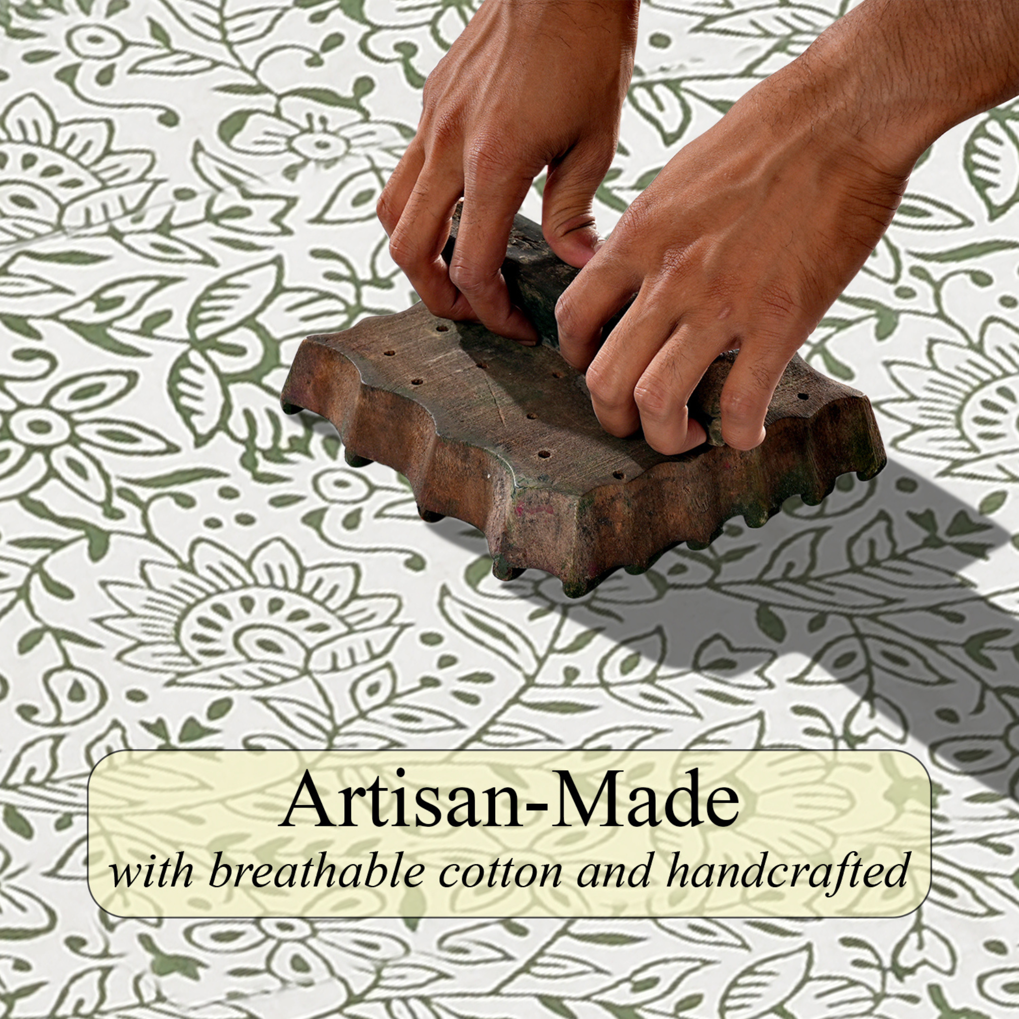 Hand using a wooden block to stamp a floral pattern on fabric with 'Artisan-Made' text overlay.