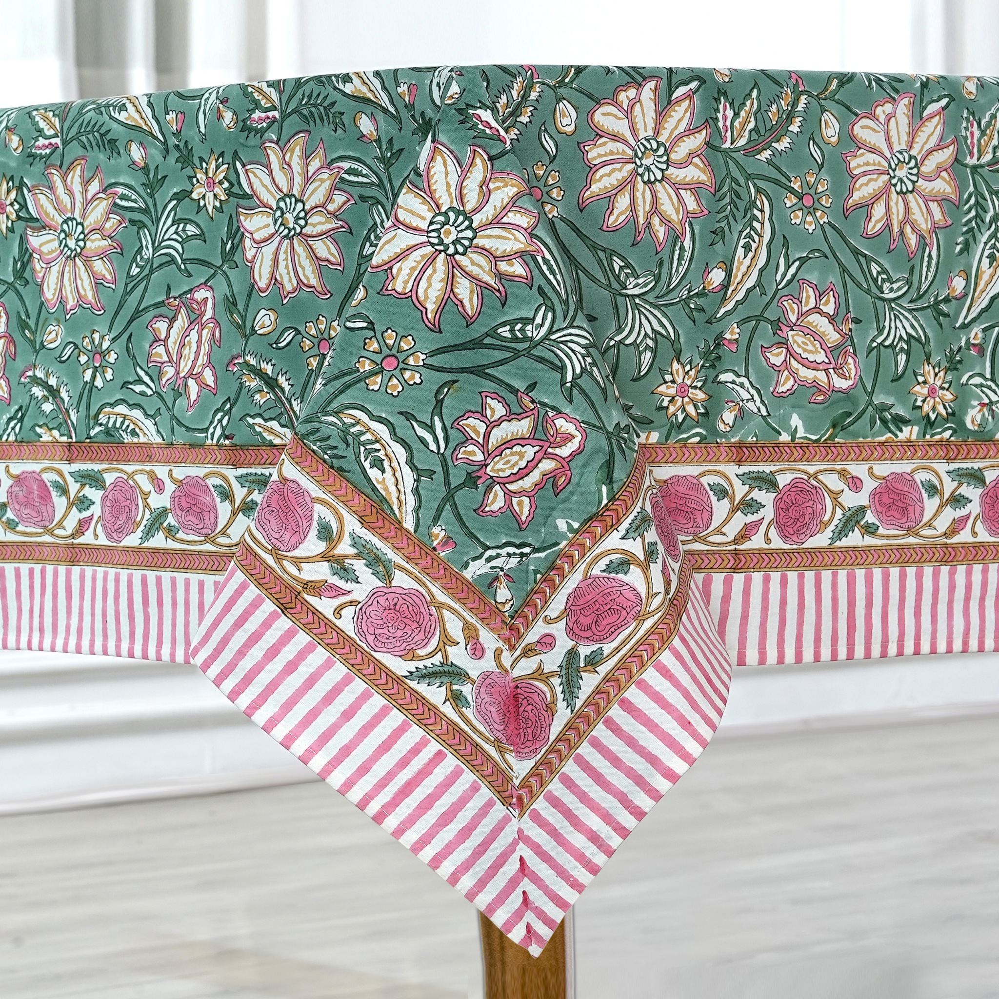 Floral and striped tablecloth on a wooden table