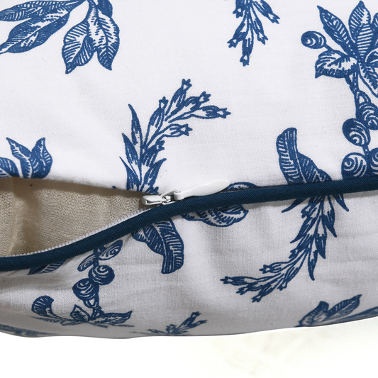 Close-up of a pillow with blue floral pattern on white background