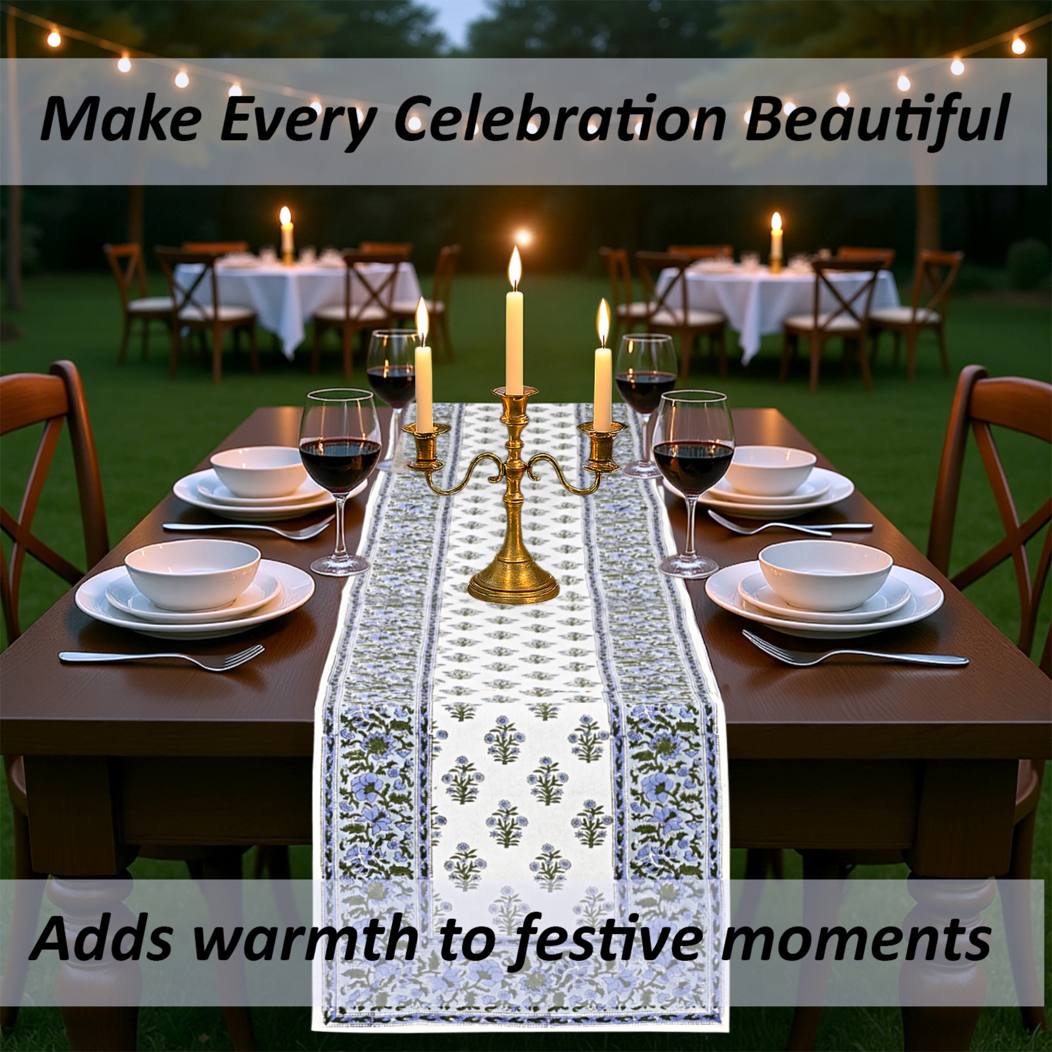 Dining table set with a decorative tablecloth, candles, and wine glasses outdoors.