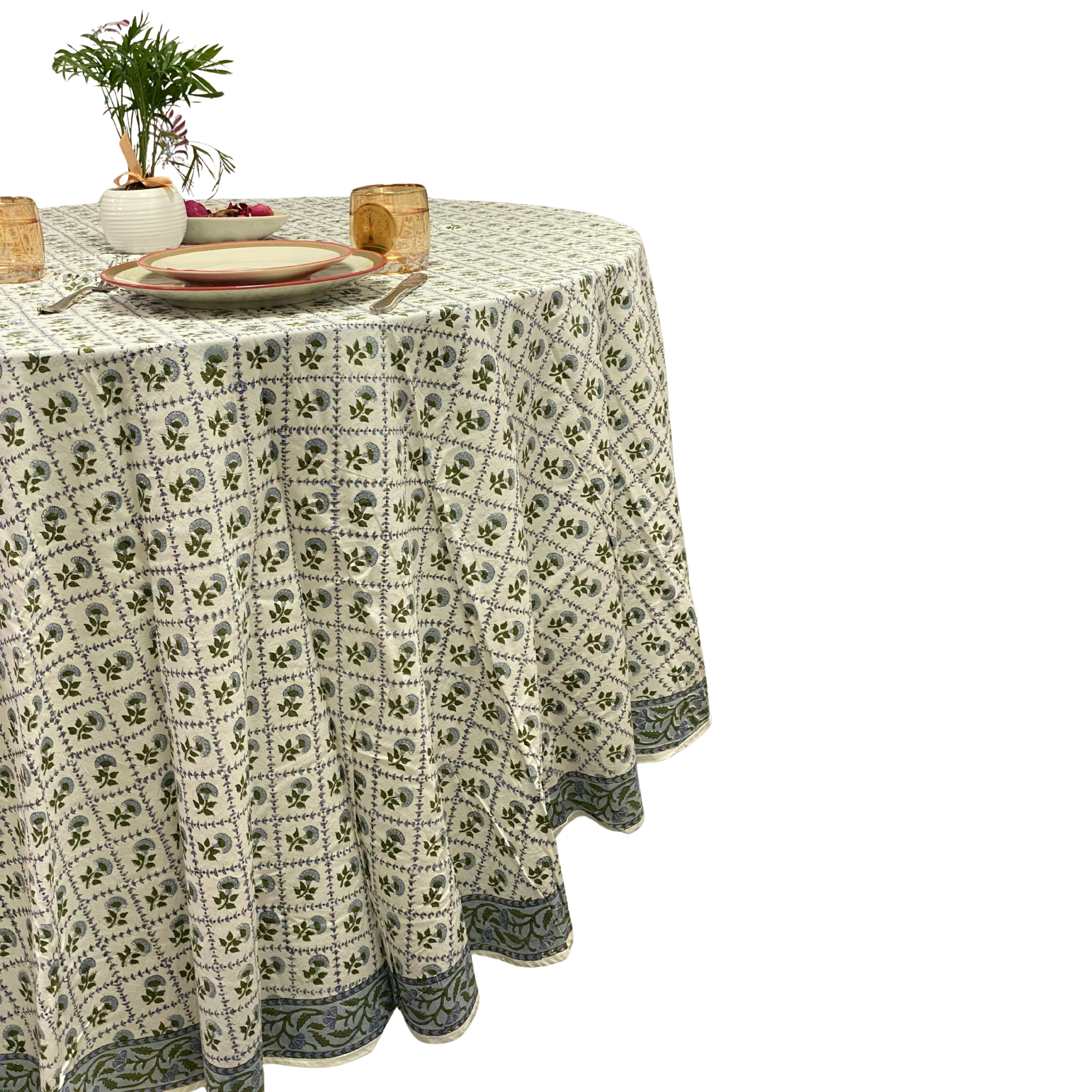 Round table with a patterned tablecloth on a white background