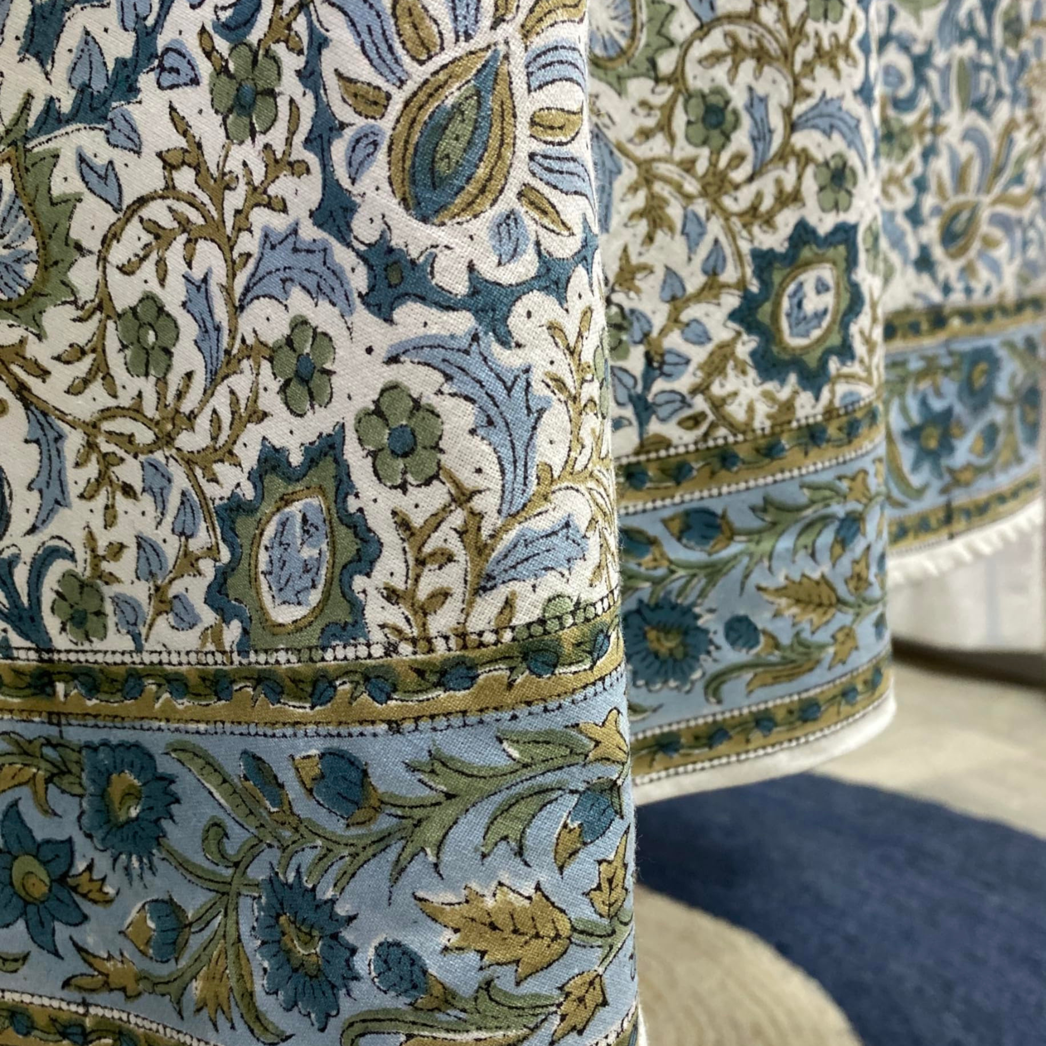 Close-up of patterned fabric with blue, green, and beige colors.