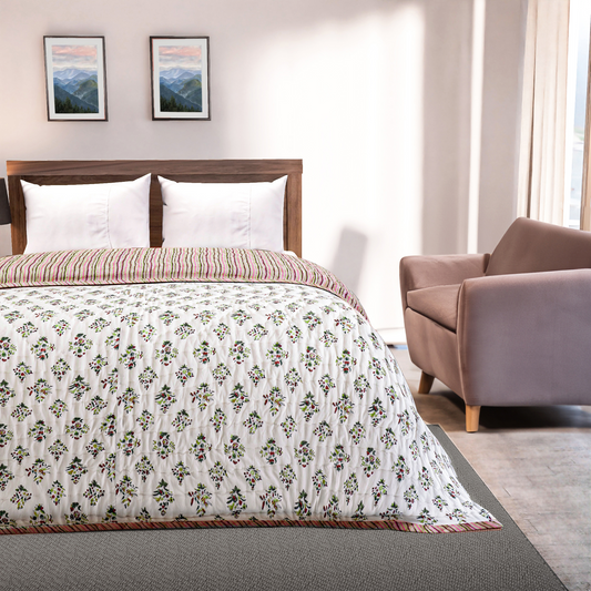 Bedroom with floral comforter, wooden headboard, and armchair.