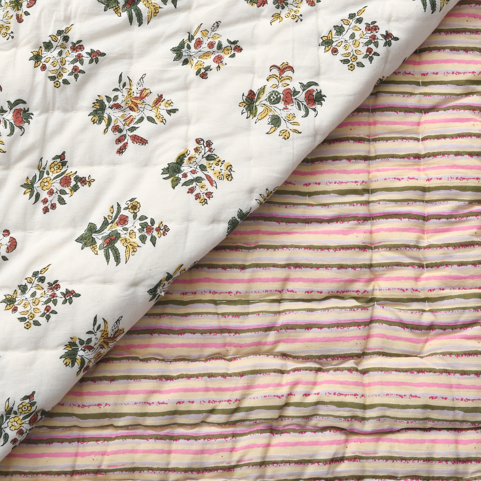 Two fabrics with floral and striped patterns on a white background