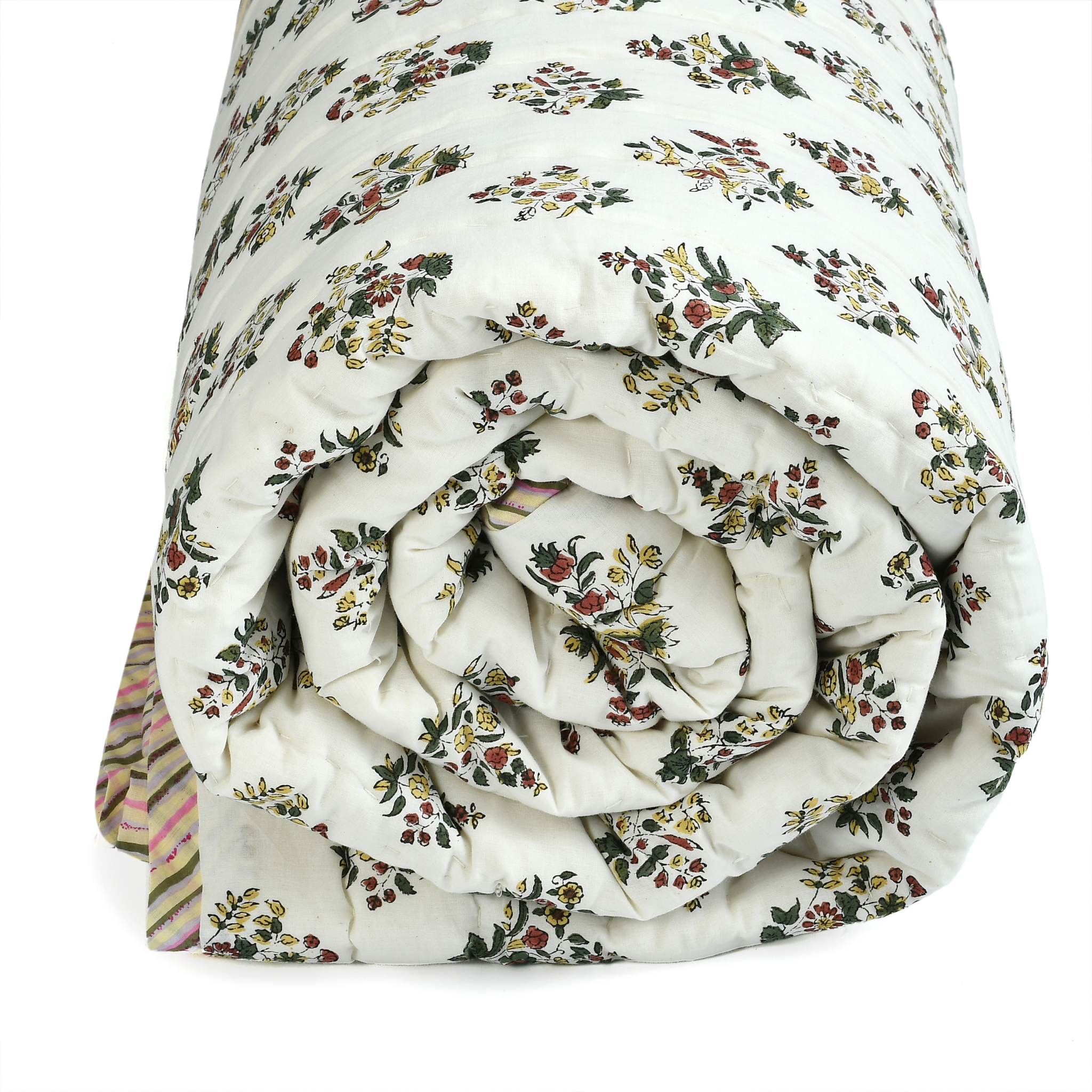 Folded floral-patterned quilt on a white background