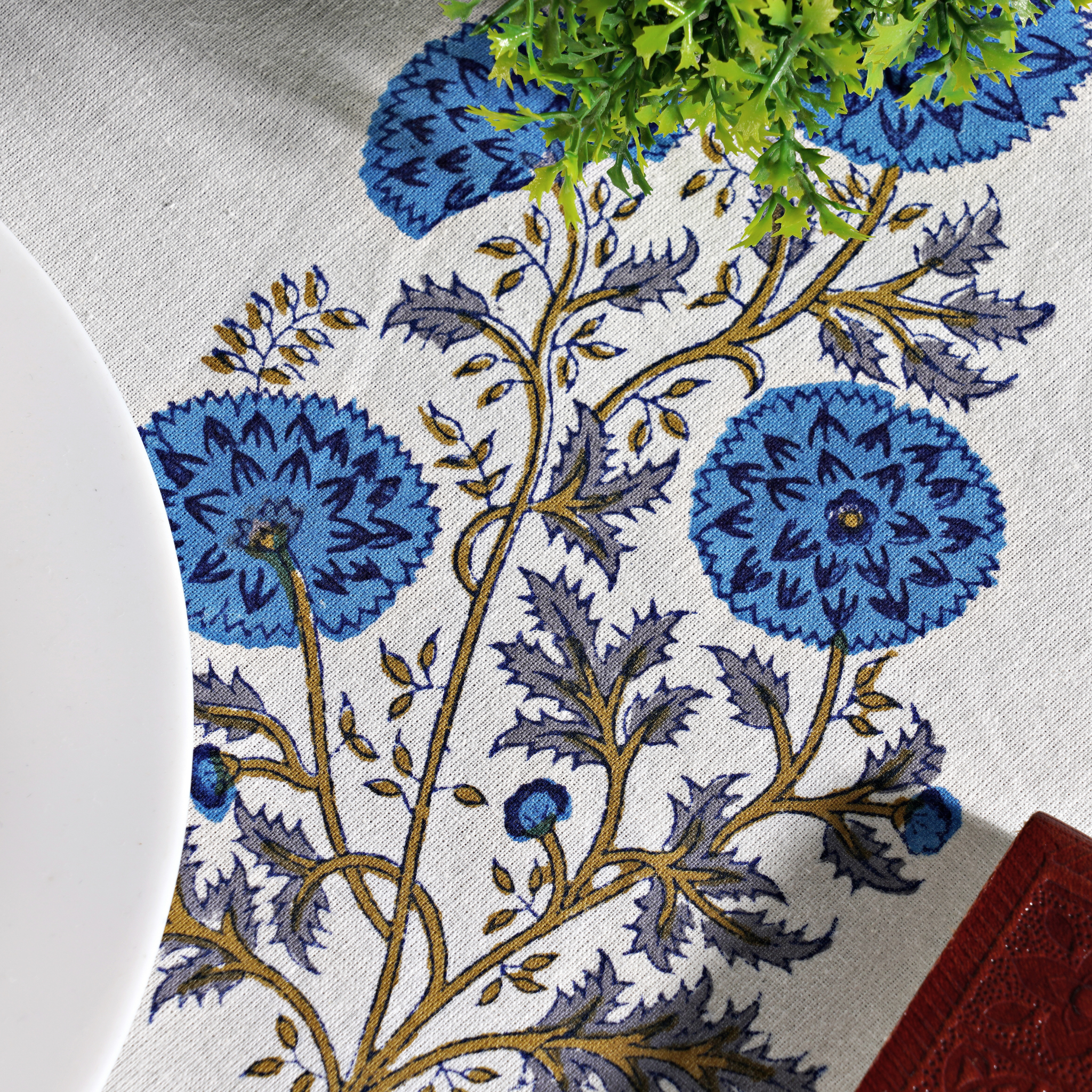 Floral patterned tablecloth with blue flowers on a white background