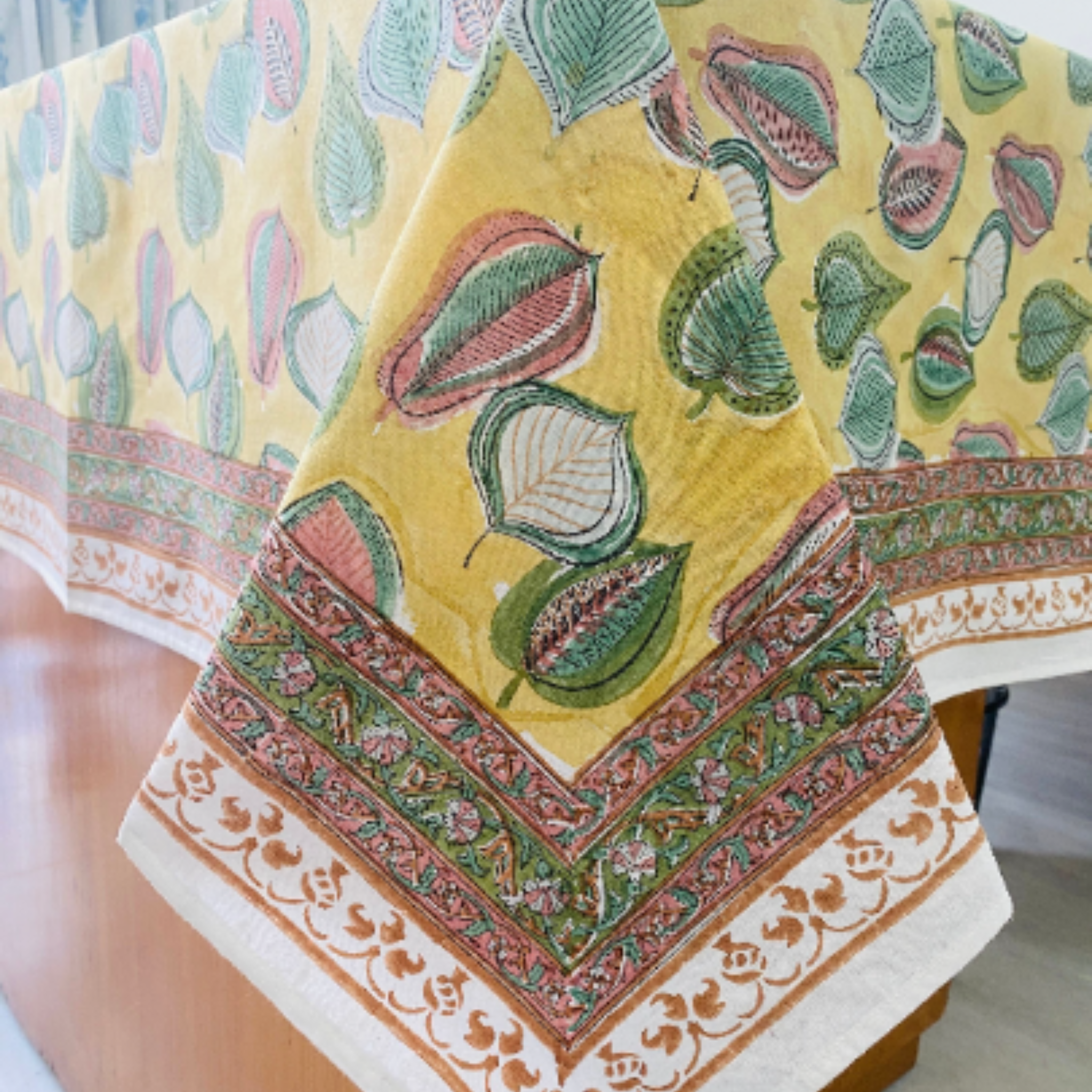 Decorative tablecloth with floral patterns on a yellow background
