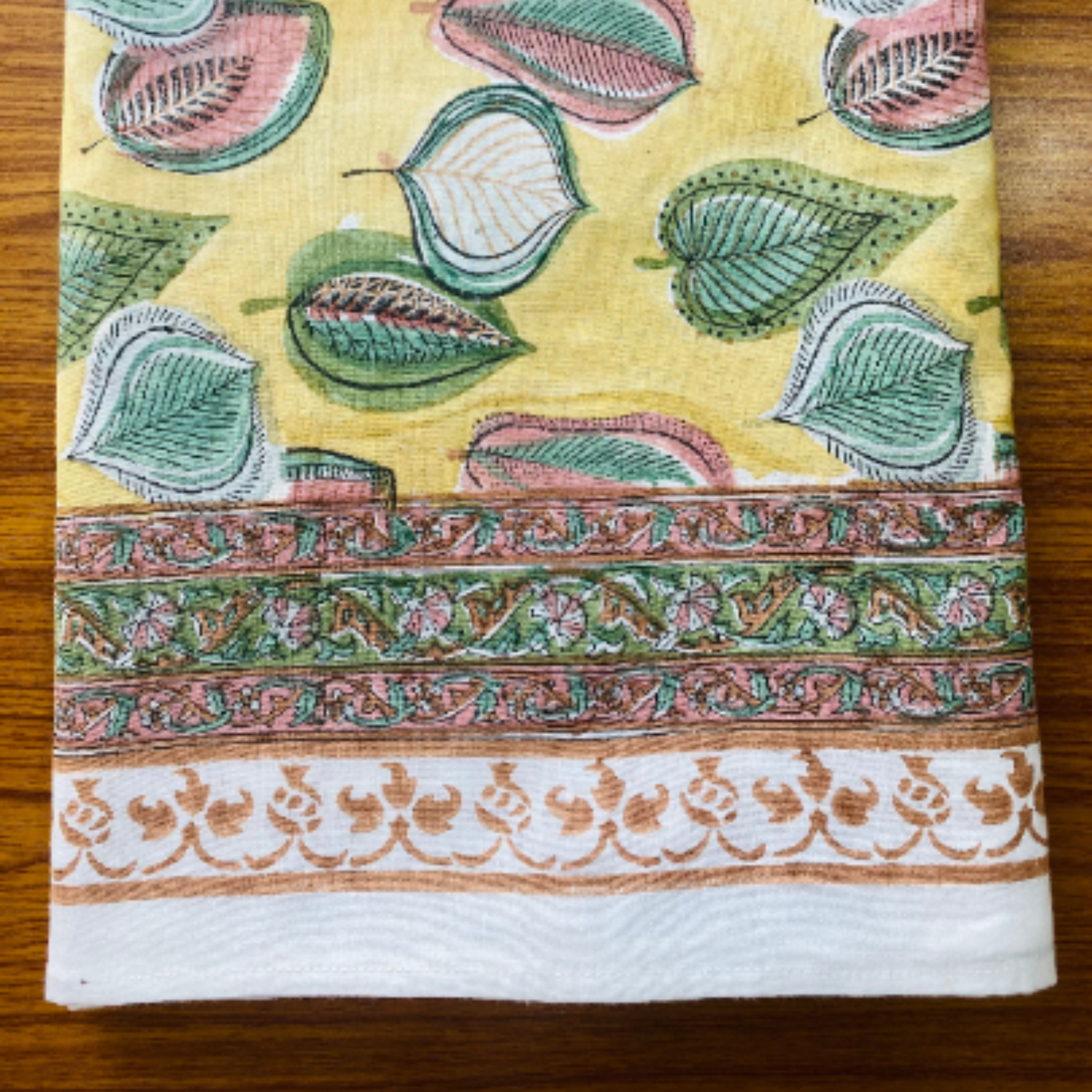 Decorative fabric with leaf patterns on a yellow background
