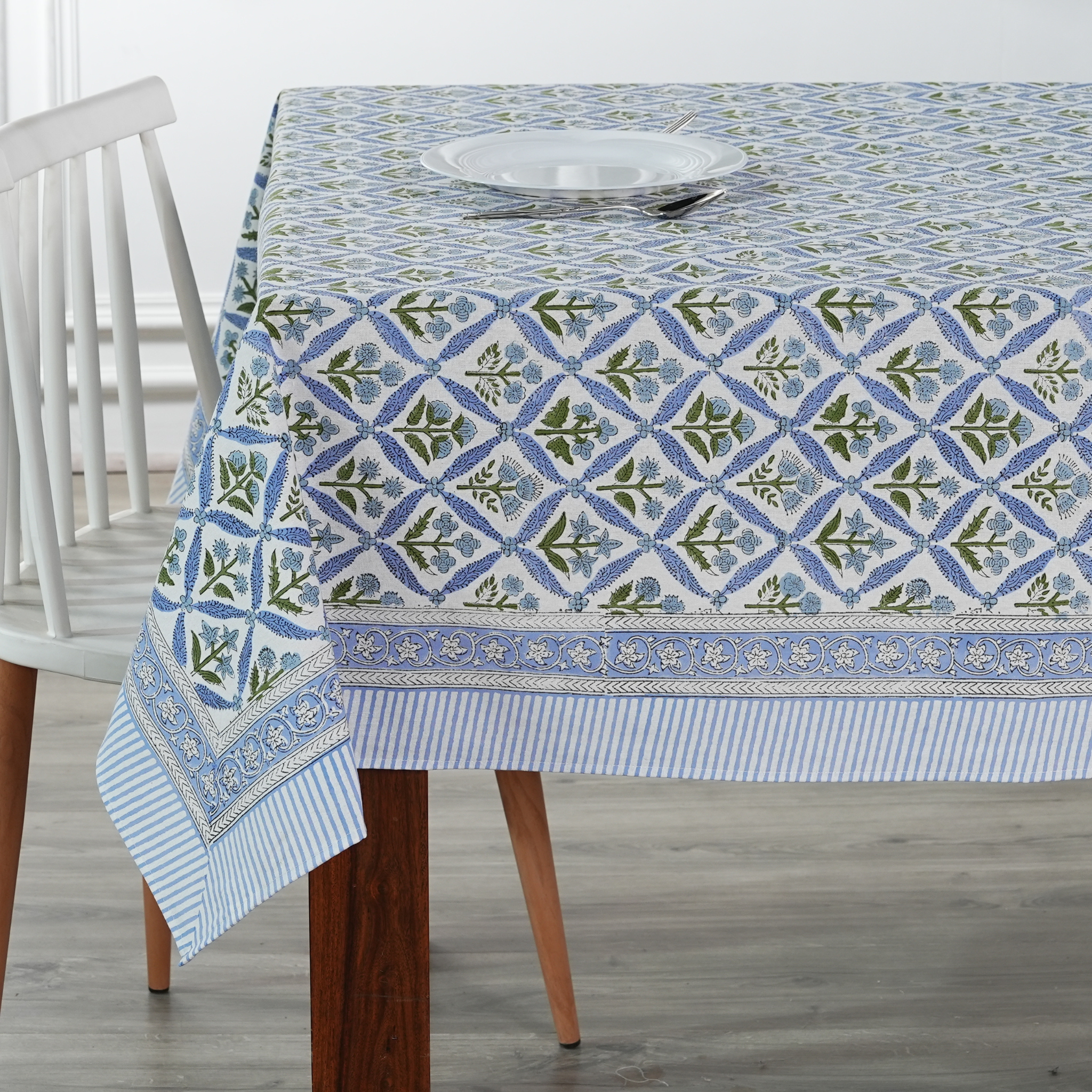 Tablecloth with blue and green pattern on a wooden table