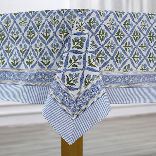 Blue and white patterned tablecloth with a geometric design on a wooden table.
