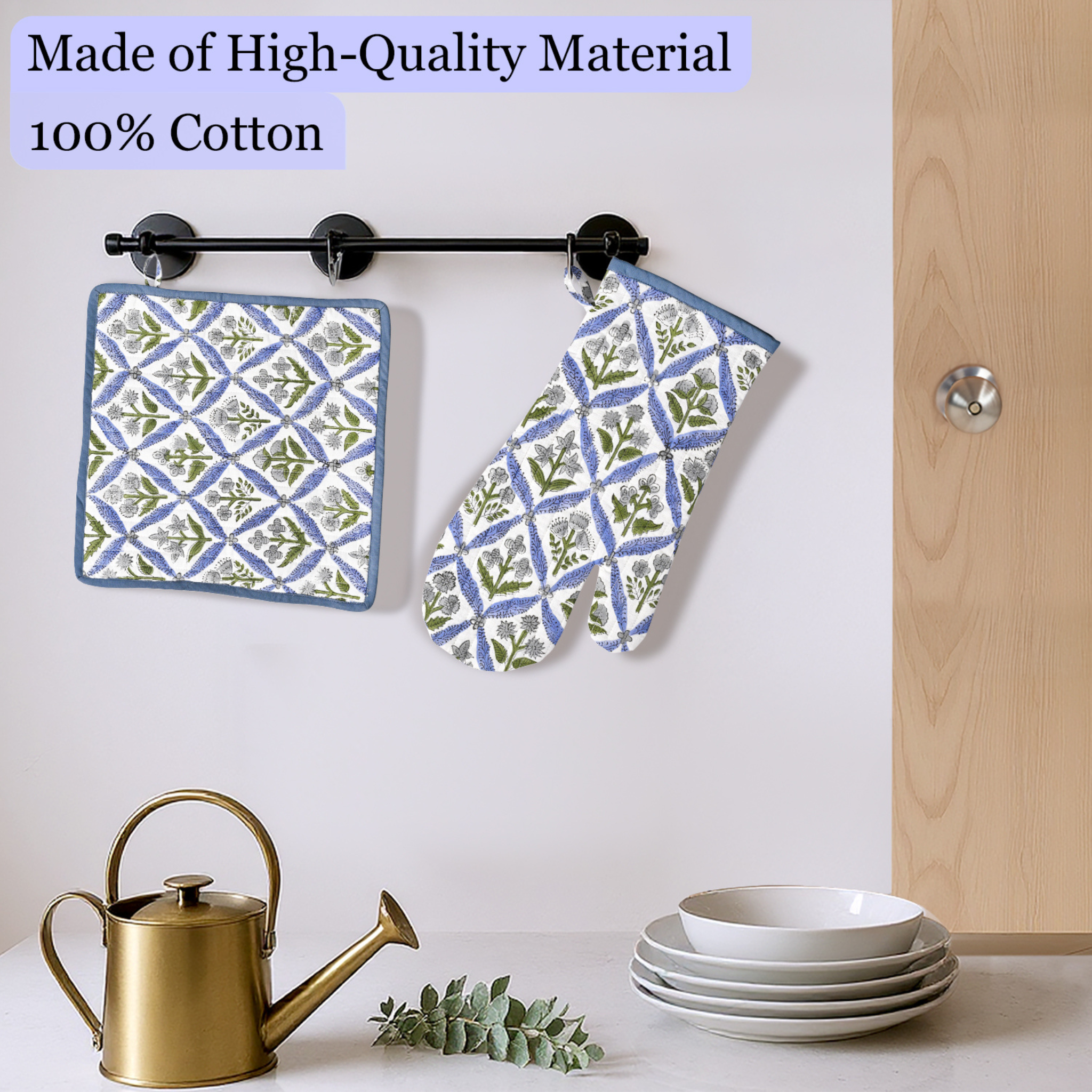 Patterned pot holder and oven mitt hanging on a rack with kitchen items below.