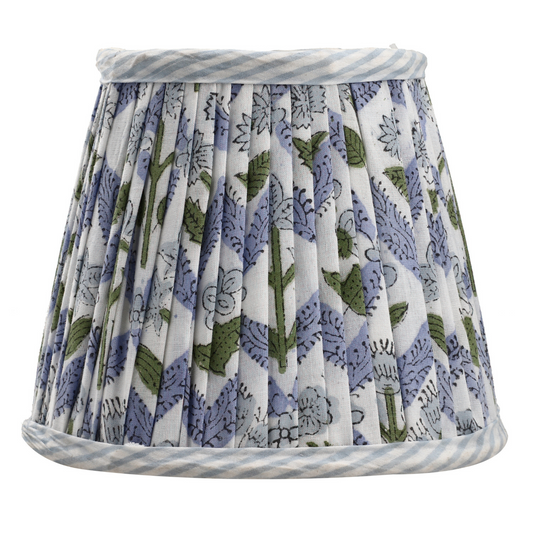 Floral patterned lampshade with blue and white stripes on a white background