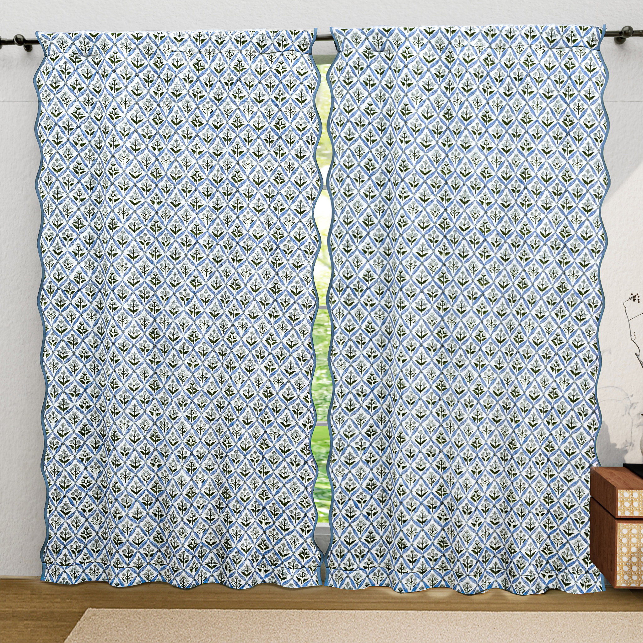Patterned curtains on a rod with a neutral background