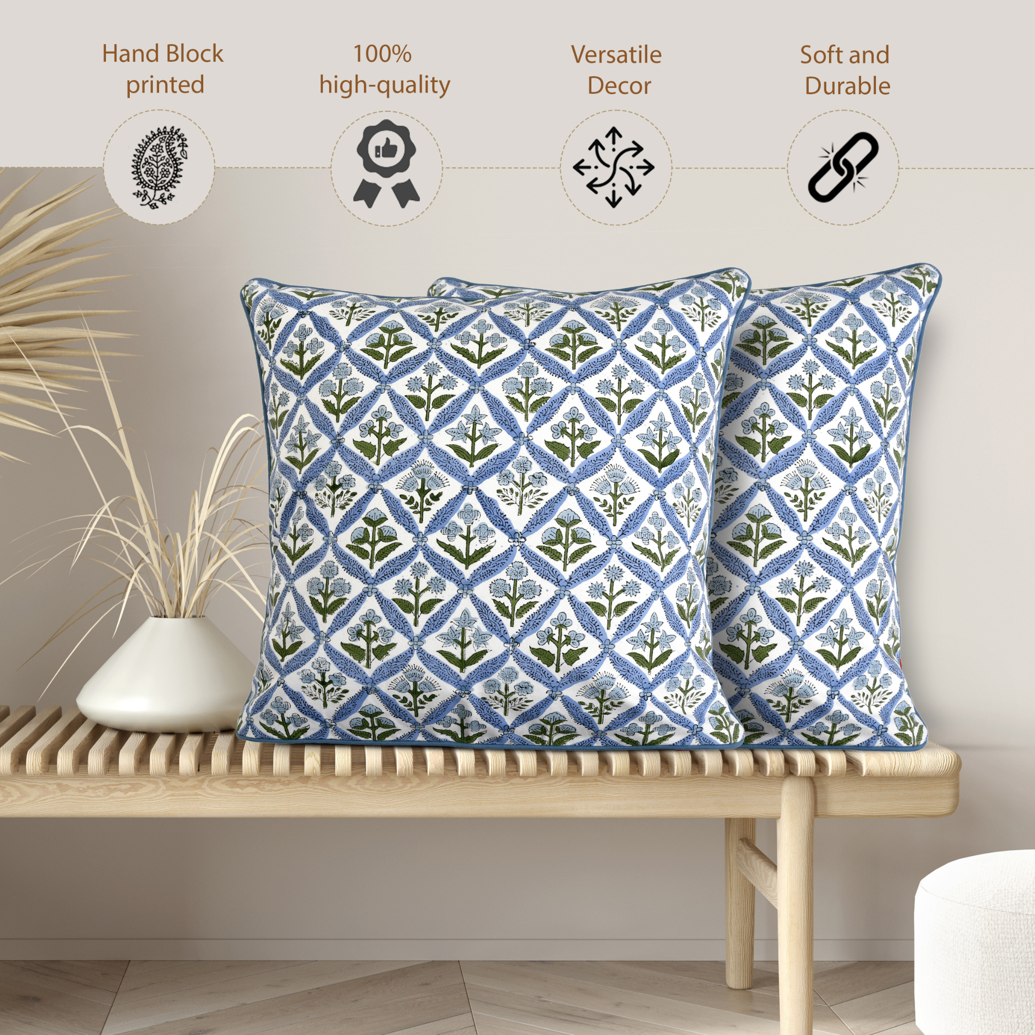 Two blue patterned pillows on a wooden bench with decorative elements.