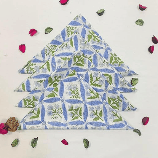 Stack of folded fabric with a floral pattern on a white background with decorative elements.