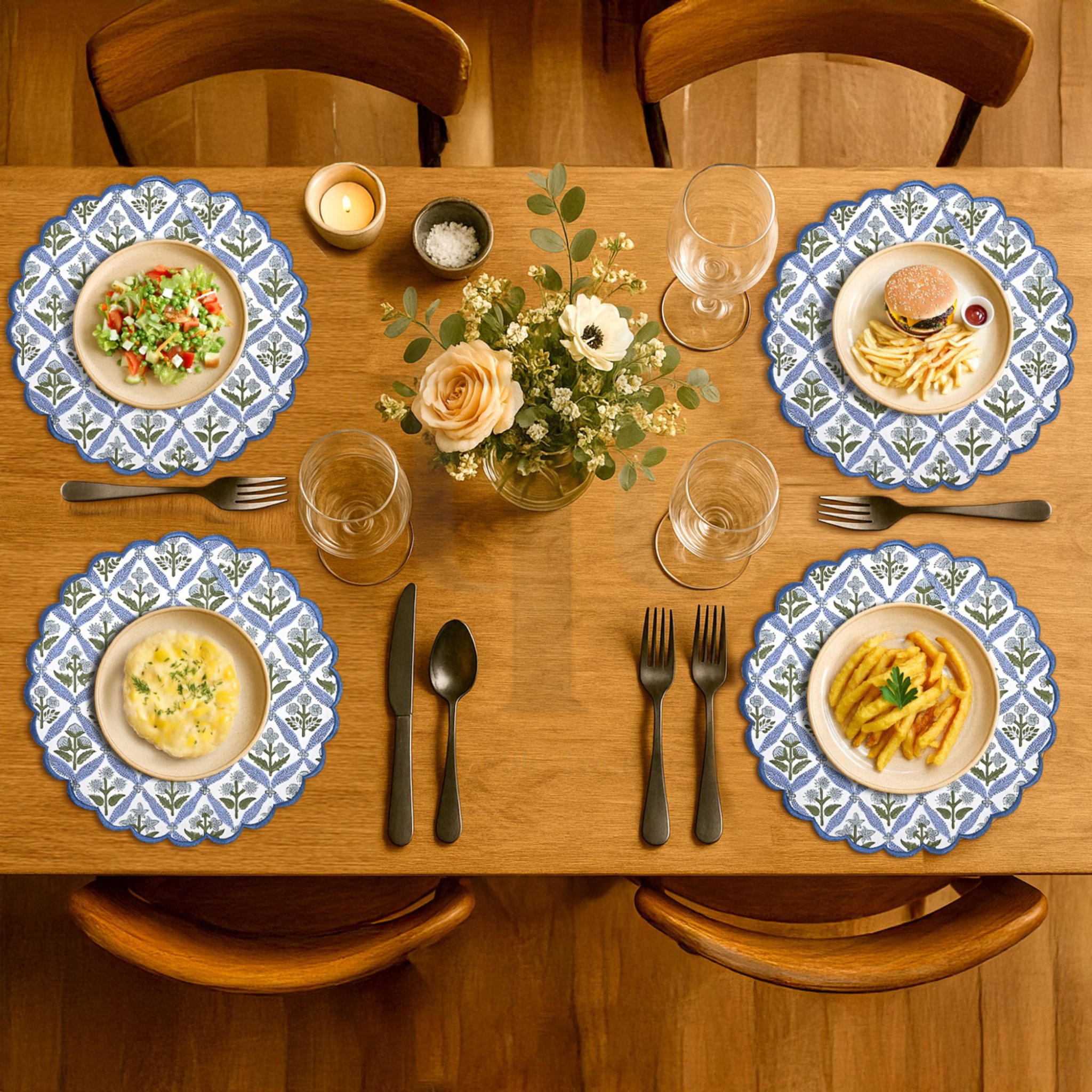 Dining table set with plates, cutlery, and a small bouquet of flowers.