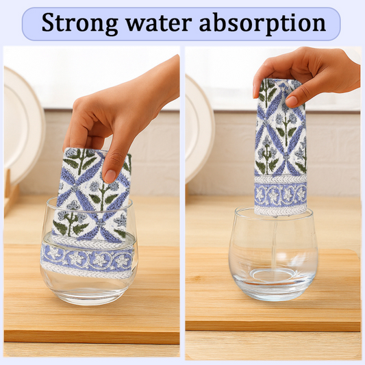 Glass with floral patterned towel absorbing water on a wooden surface