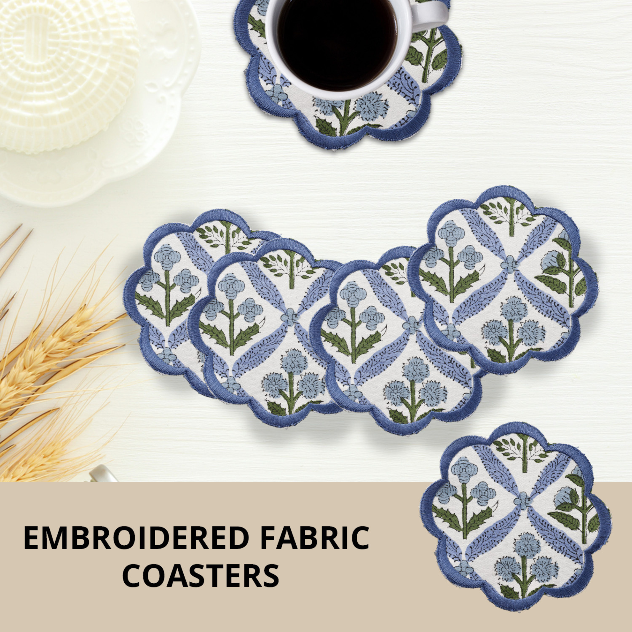 Set of embroidered fabric coasters with a cup of coffee and straw on a white surface.