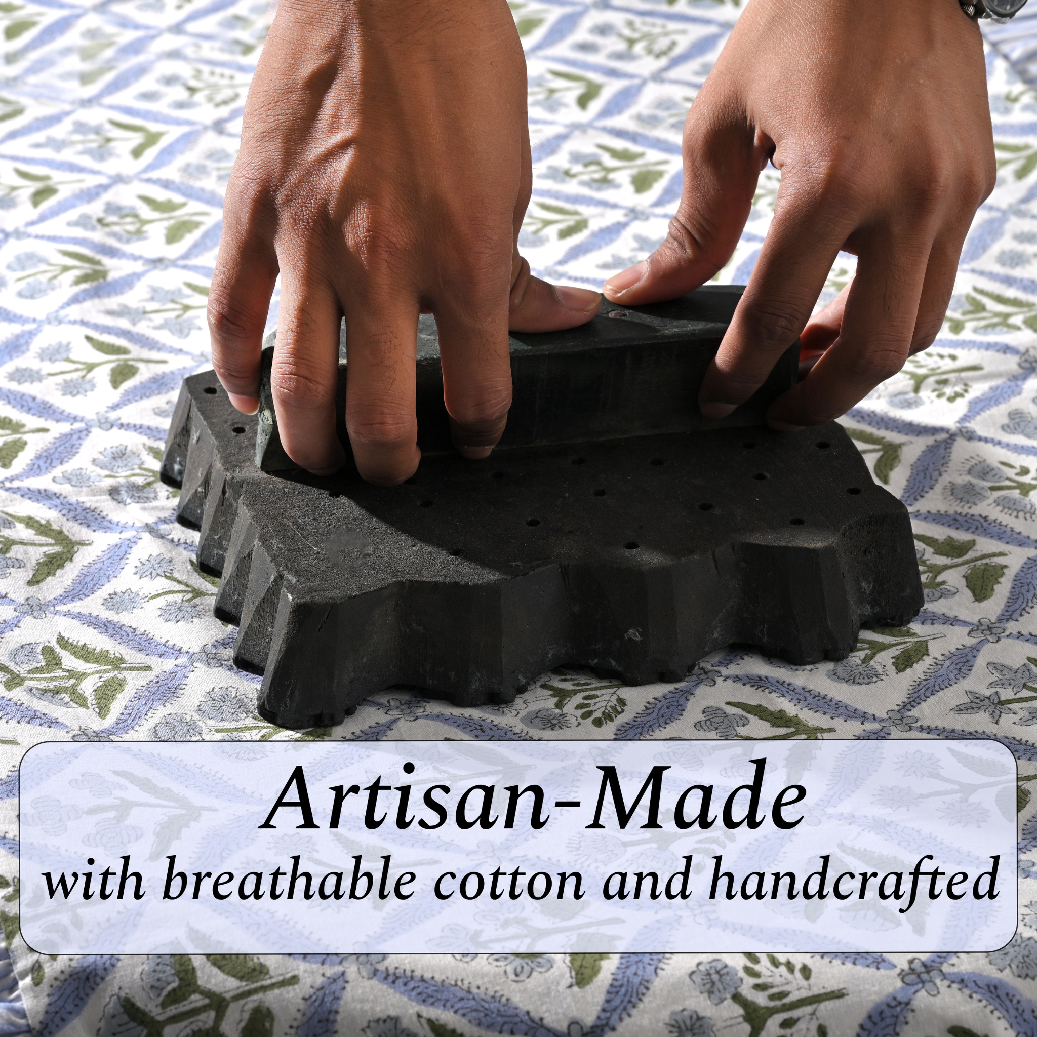 Black rubber mat with textured surface being held by hands on a patterned fabric background, with text 'Artisan-Made with breathable cotton and handcrafted'.