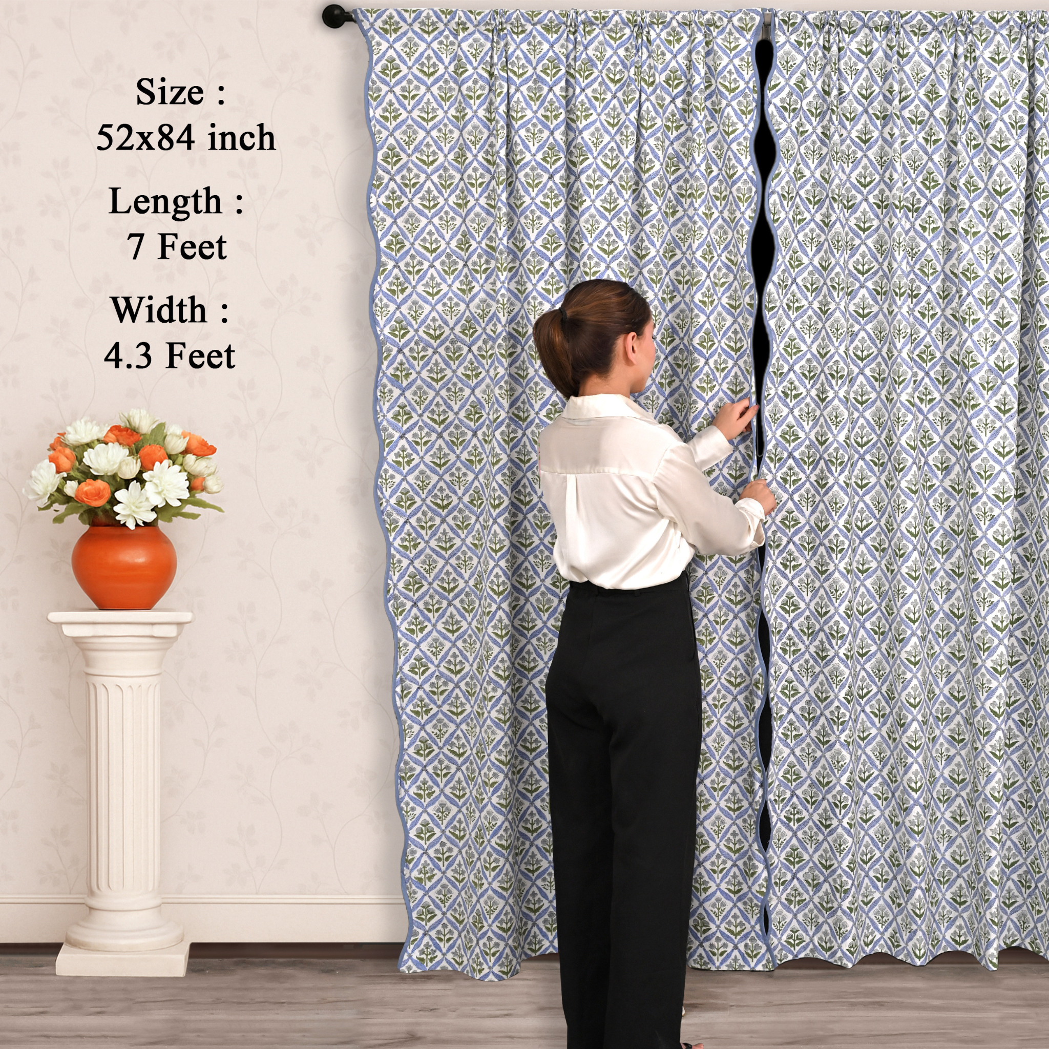 Person holding a large patterned curtain with measurements displayed