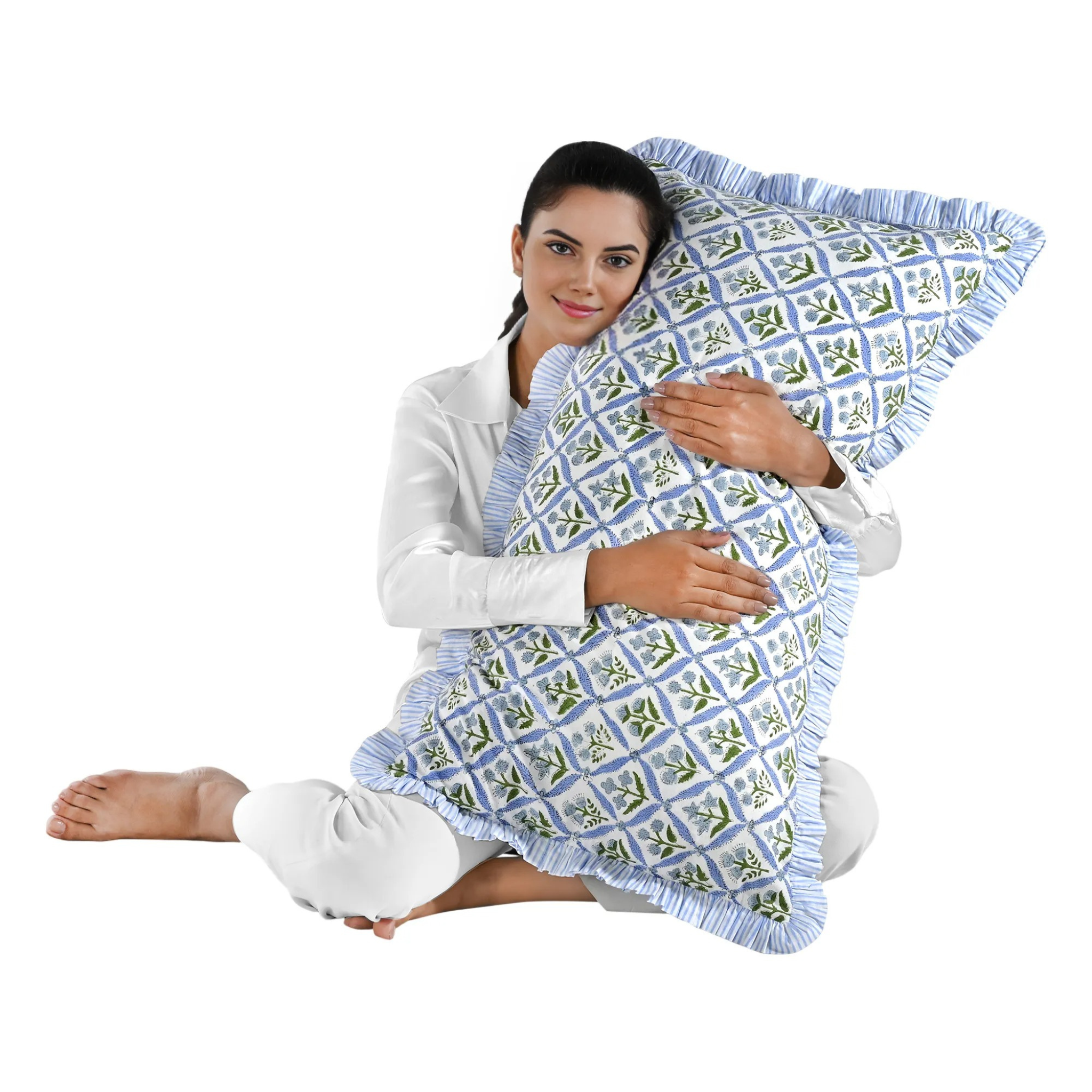 Woman holding a large blue floral block print cotton pillow with green edges.