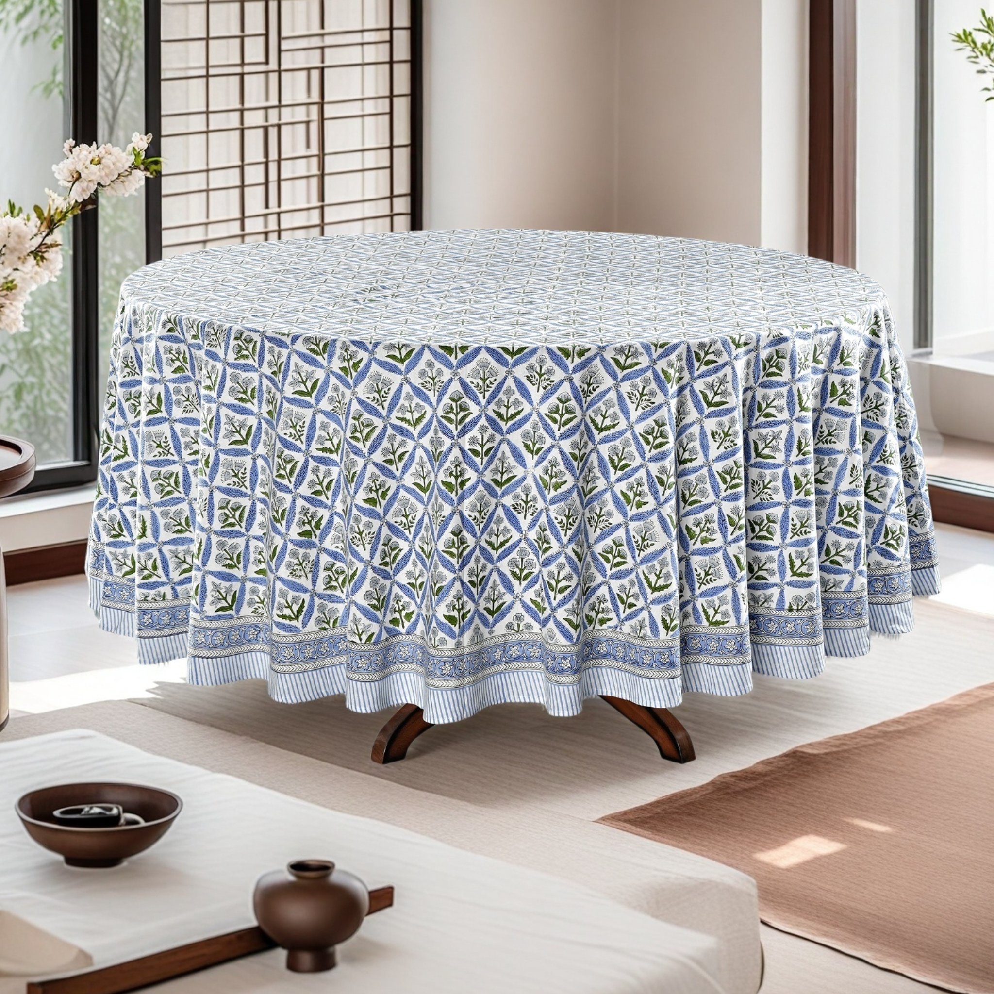 Tablecloth with geometric pattern on a round table in a room with large windows.