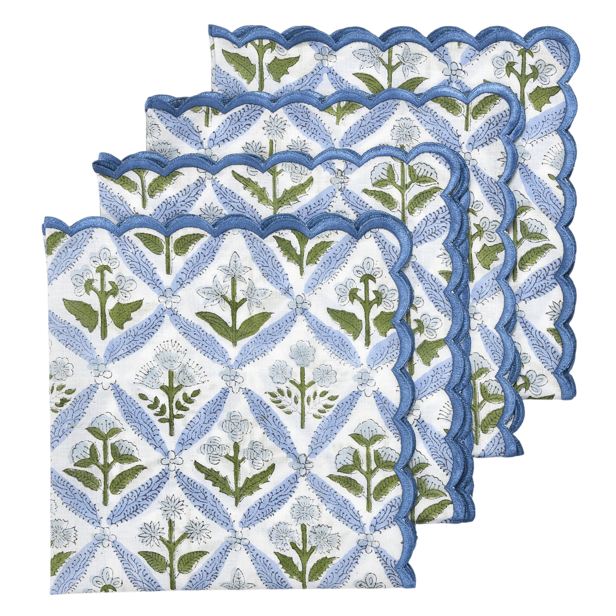 Set of four floral patterned napkins with scalloped edges on a white background