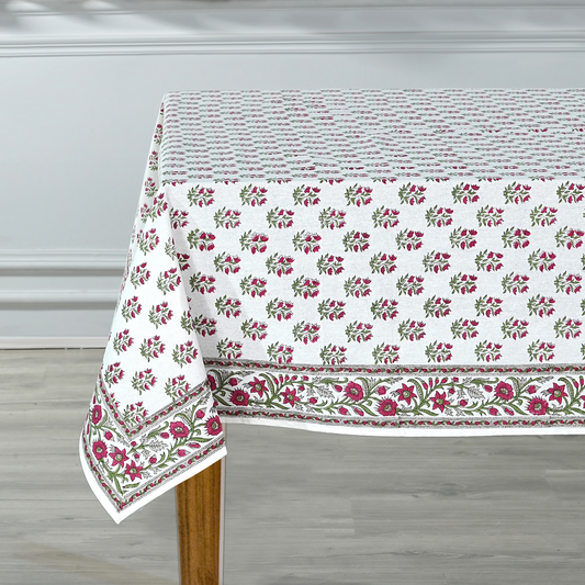 Floral patterned tablecloth on a wooden table with a neutral background