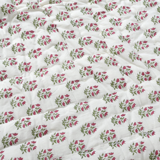 Floral patterned fabric with pink and green flowers on a white background