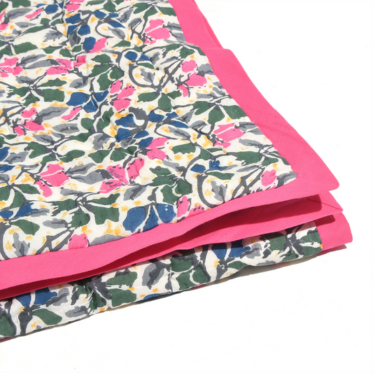 Floral-patterned fabric with pink border on a white background