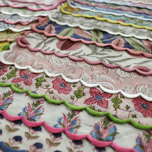 Close-up of colorful scalloped fabric edges with floral patterns