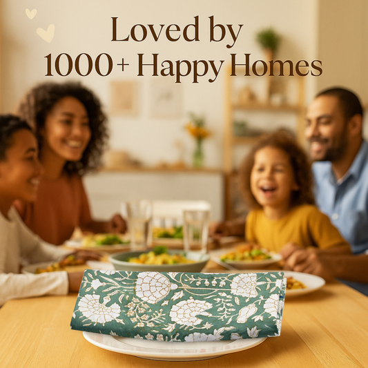 Family sitting around a dinner table with a floral-patterned package in the foreground, text 'Loved by 1000+ Happy Homes' above.