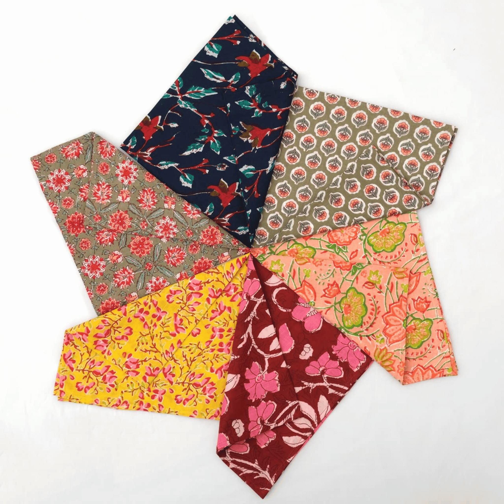 Set of six floral-patterned fabric swatches in various colors on a white background