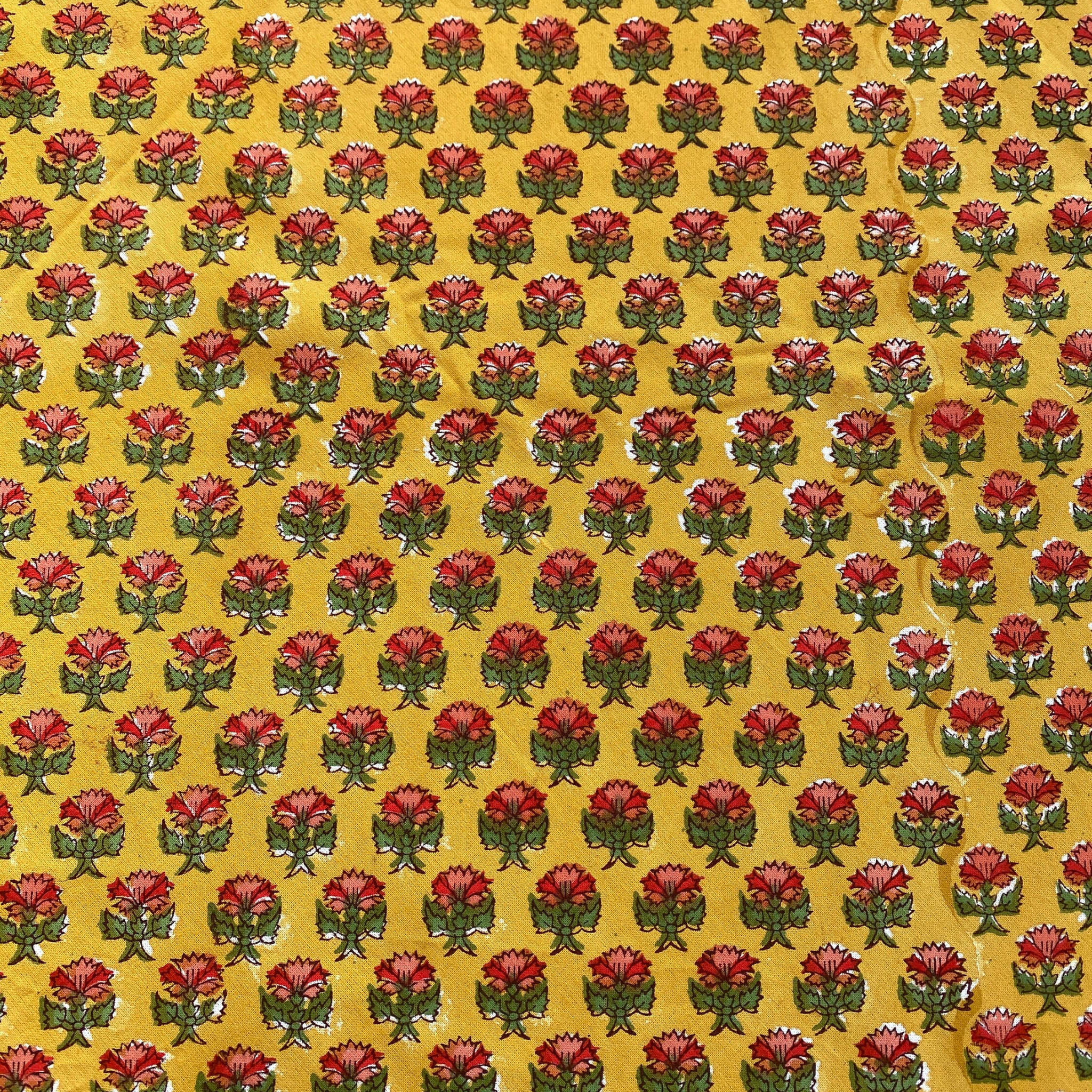 Pattern of red flowers with green stems on a yellow background