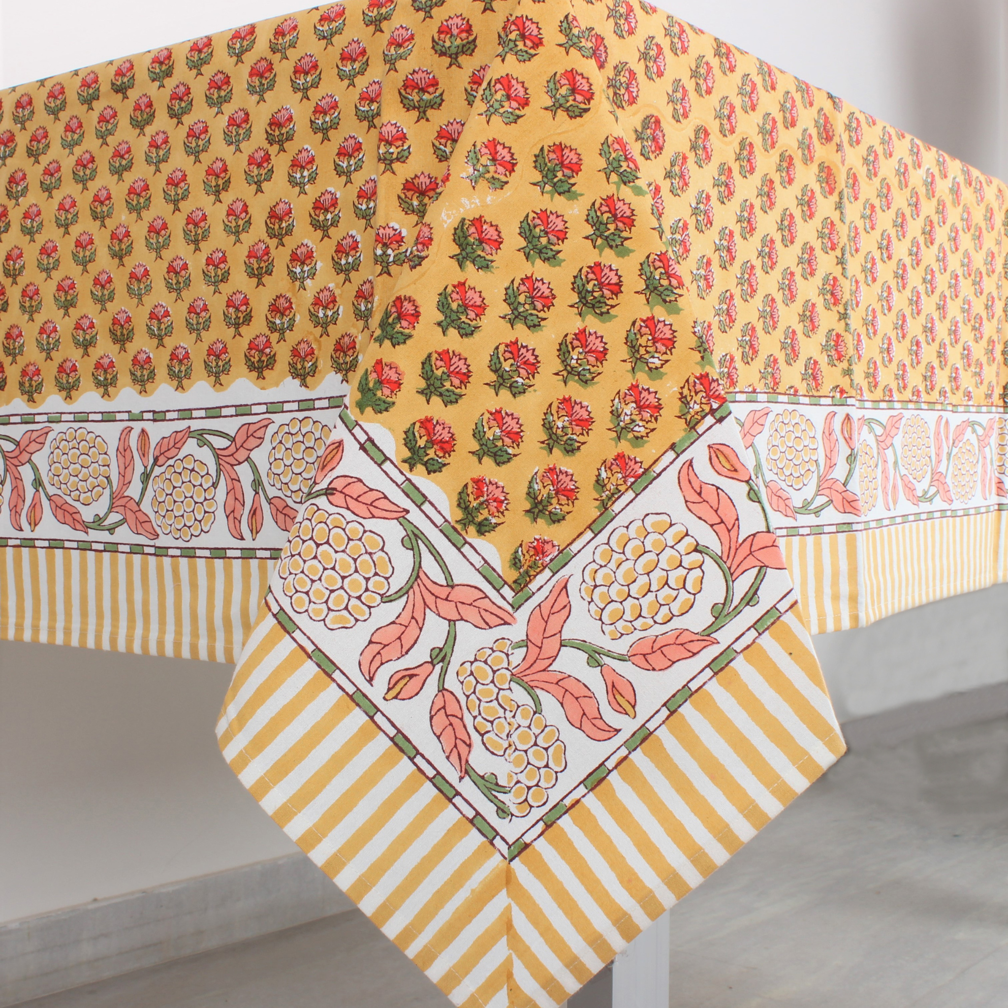 Decorative tablecloth with floral and striped patterns on a plain background