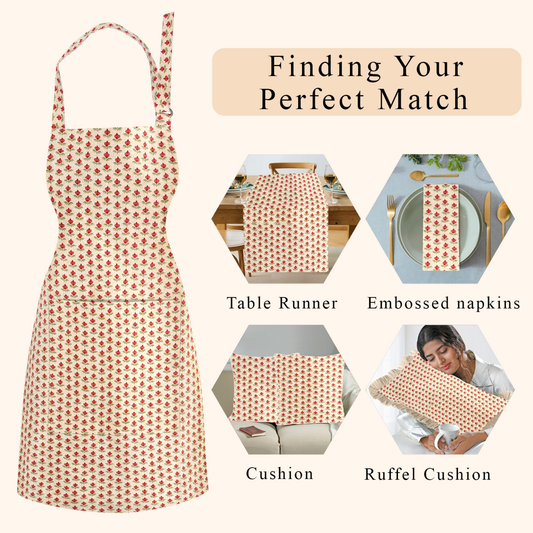 Product display of a patterned apron with matching table runner, napkins, cushion, and ruffel cushion on a white background.