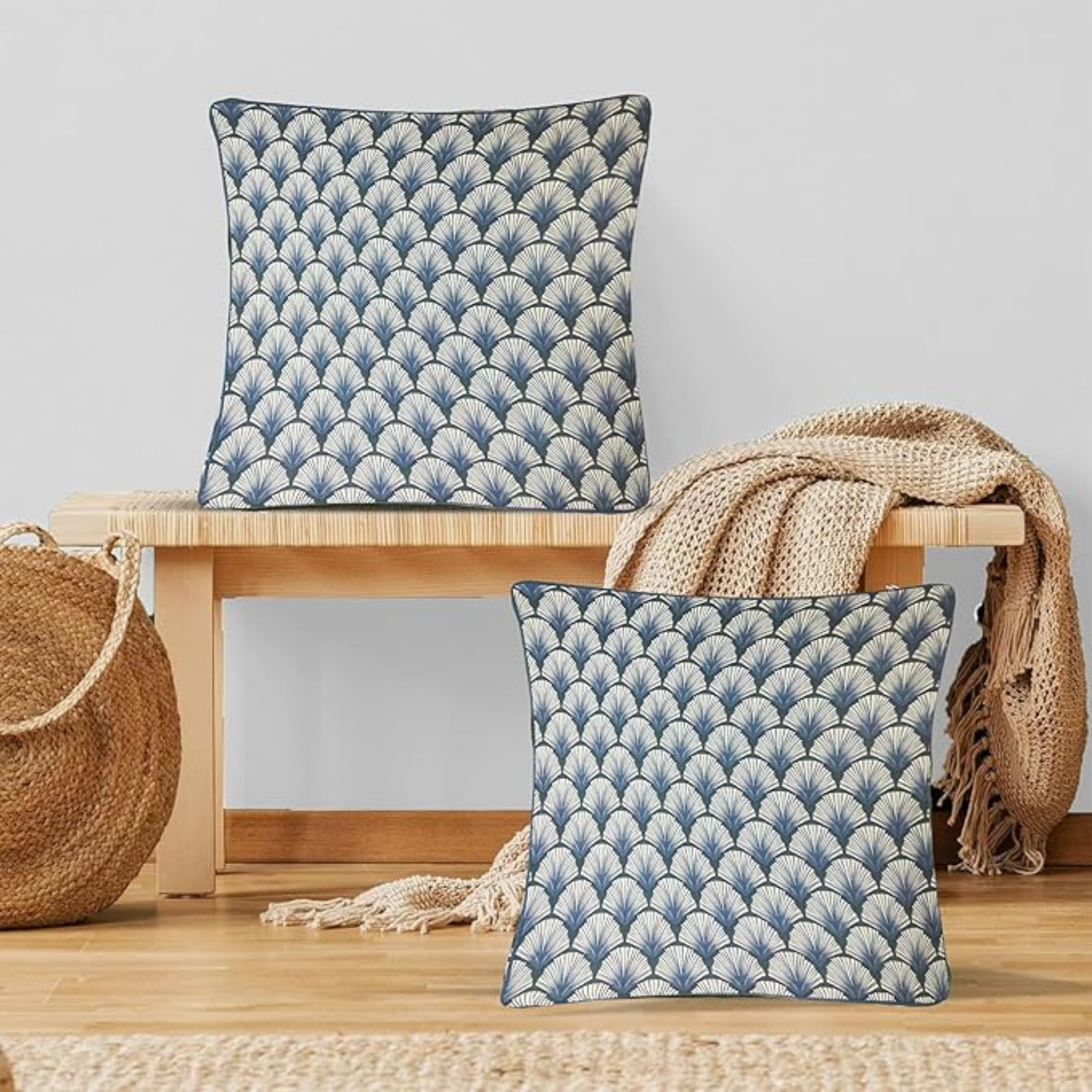 Two blue patterned cushions on a wooden stool with a neutral background