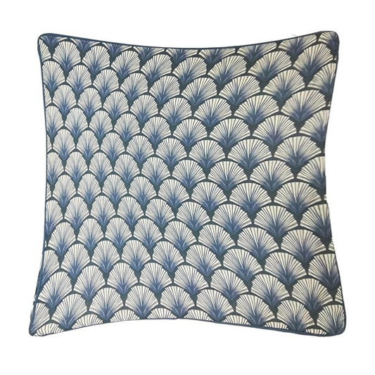Decorative pillow with blue and white shell pattern on a white background