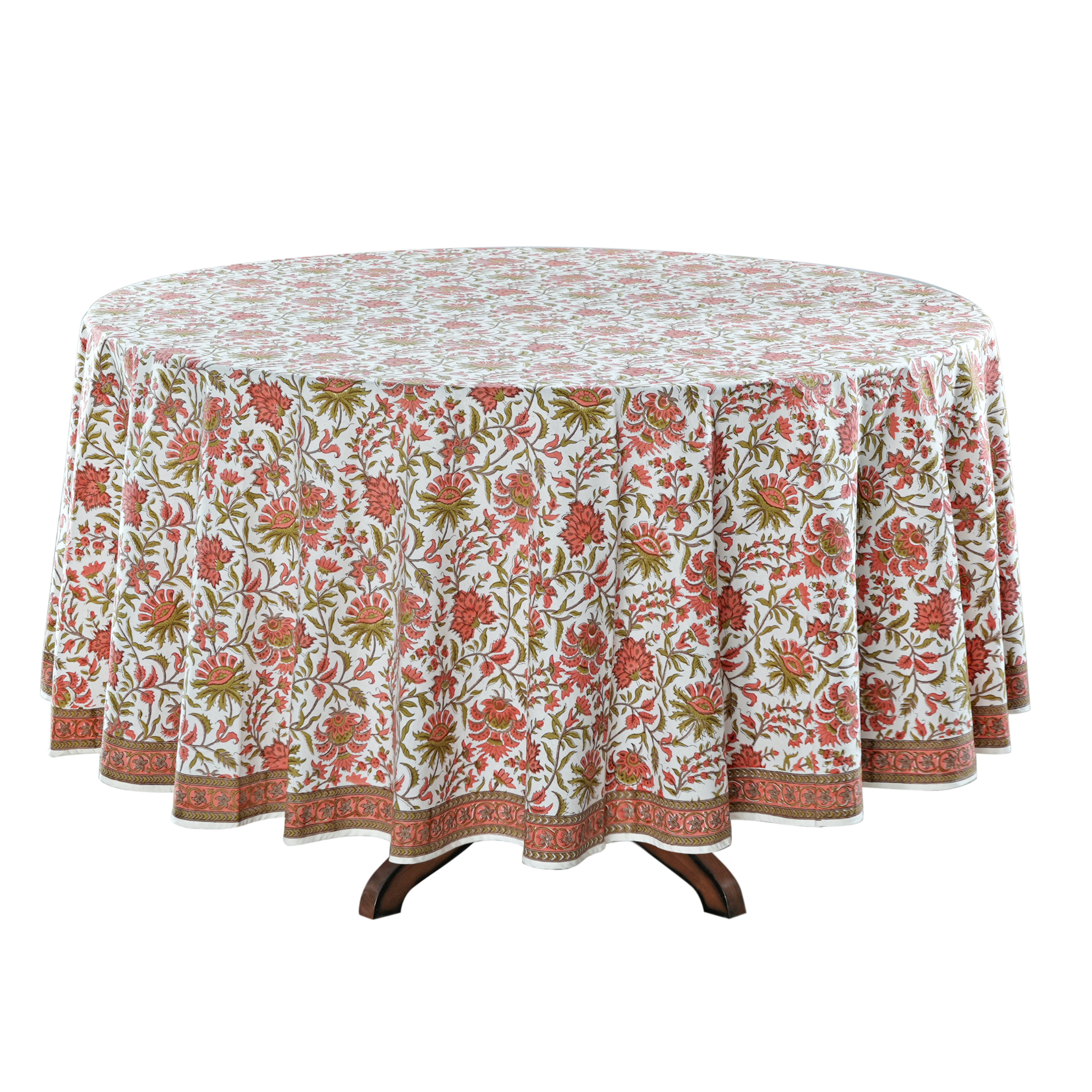 Round table with a floral patterned tablecloth on a white background