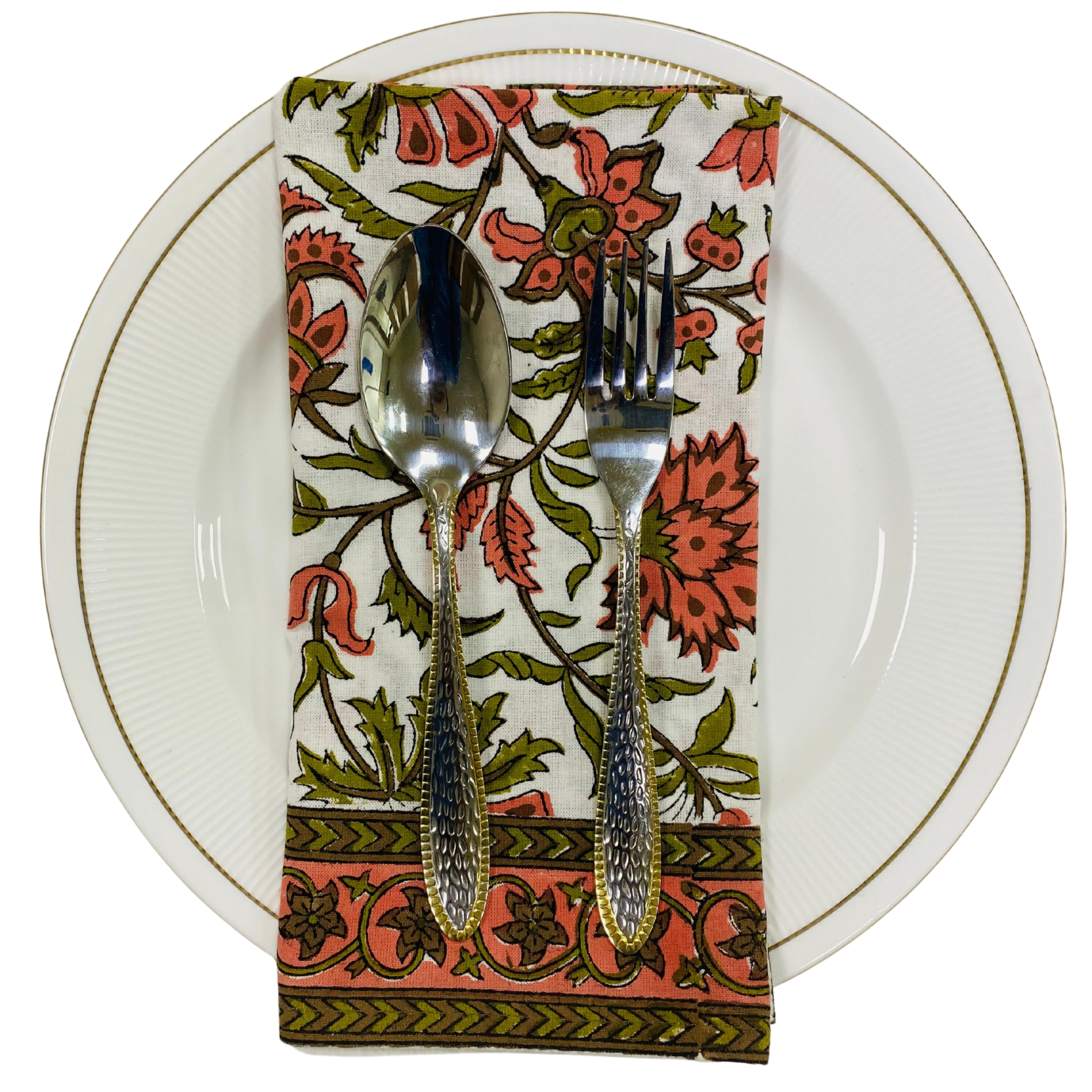 Decorative floral napkin with cutlery on a white plate