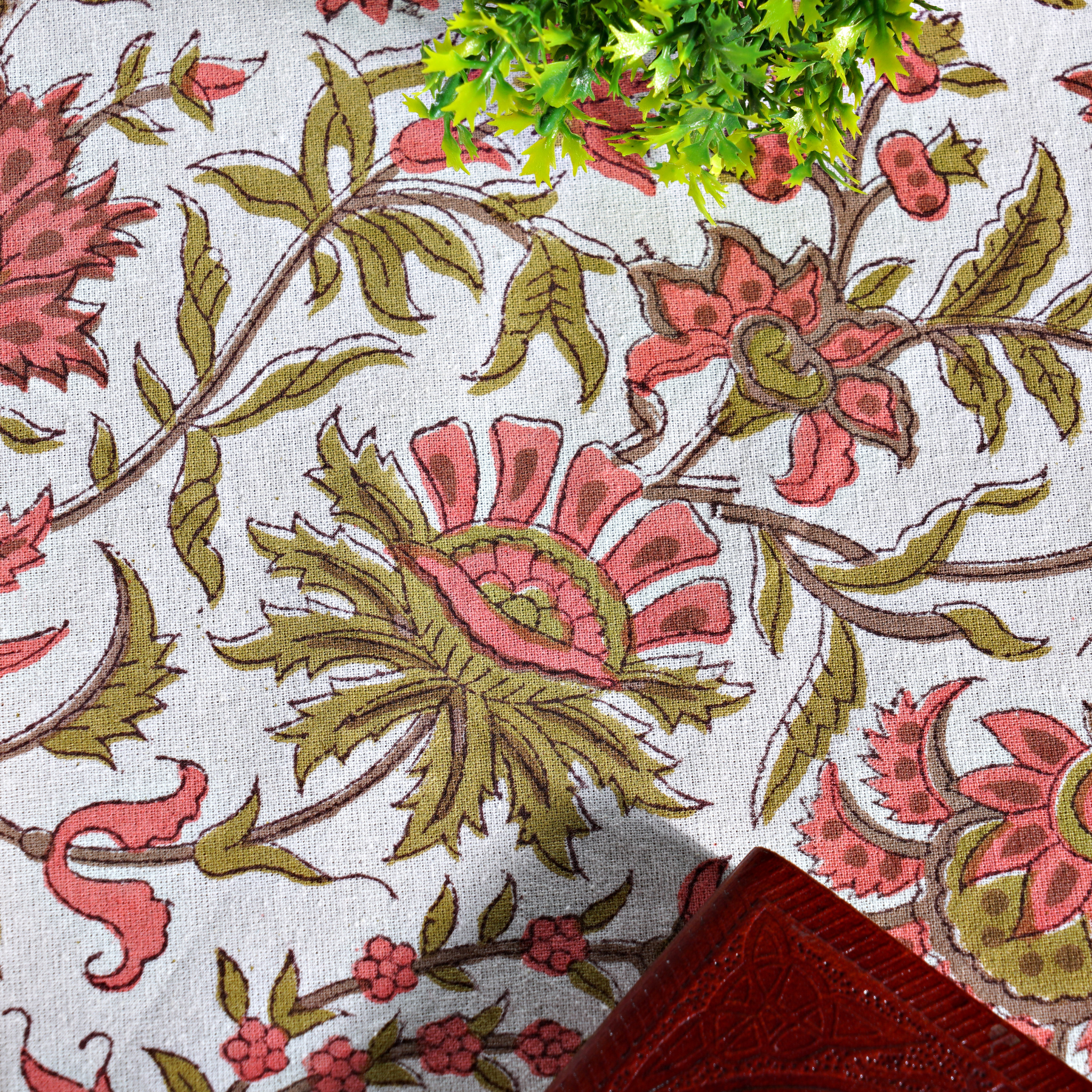 Floral patterned fabric with pink and green flowers on a white background