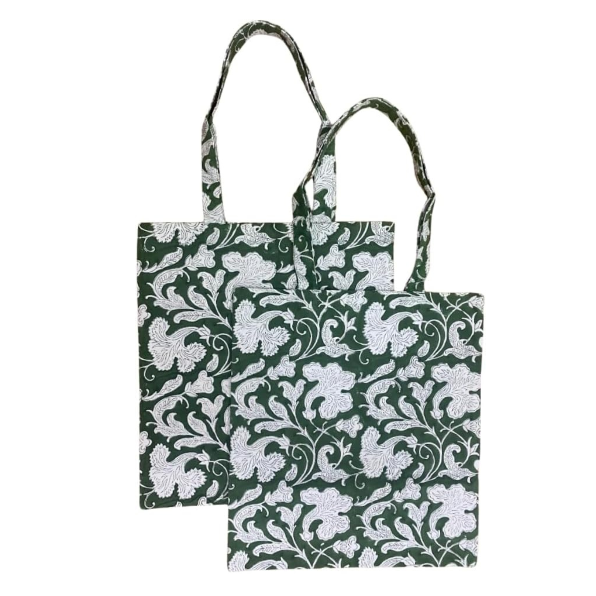 Two green tote bags with white floral patterns on a white background