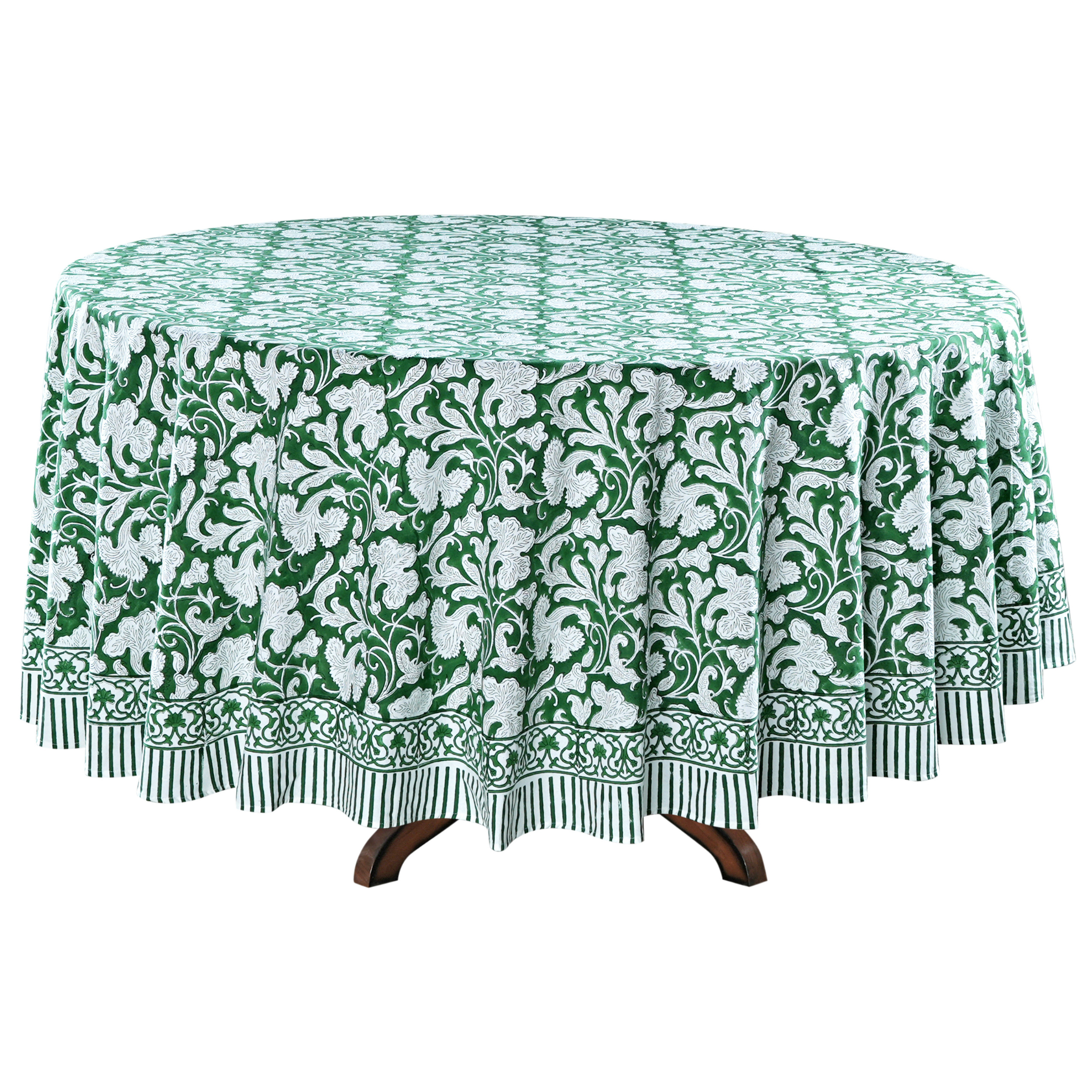 Green and white floral patterned tablecloth on a round table.