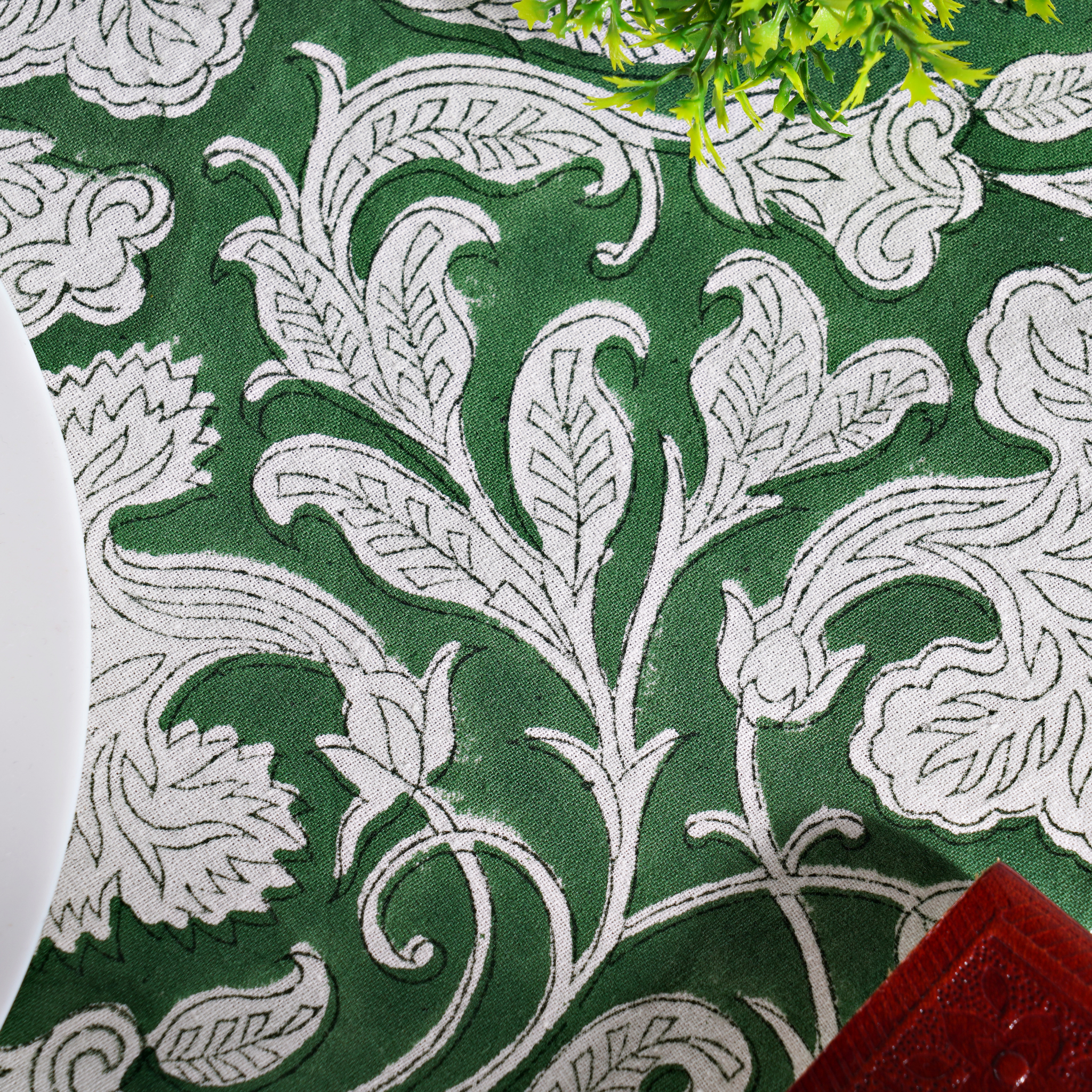 Close-up of a green fabric with white floral patterns