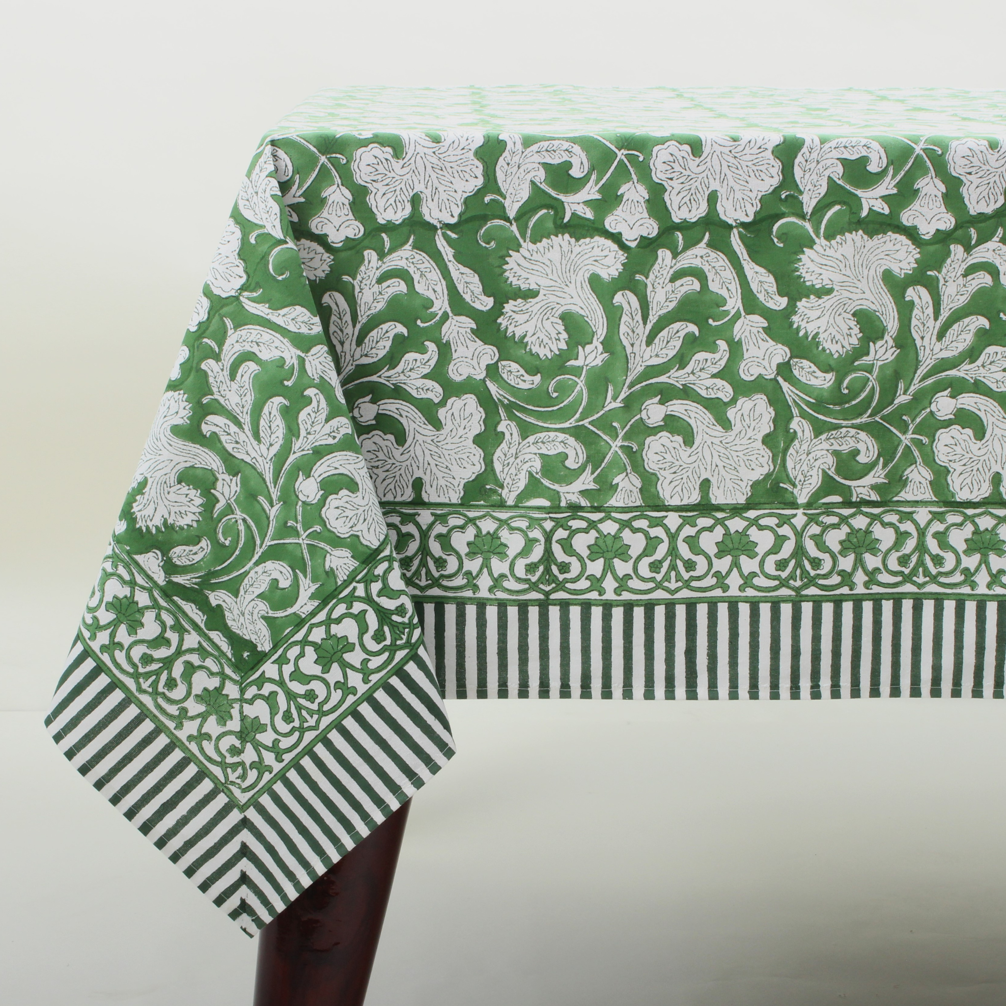 Green and white patterned tablecloth on a plain background